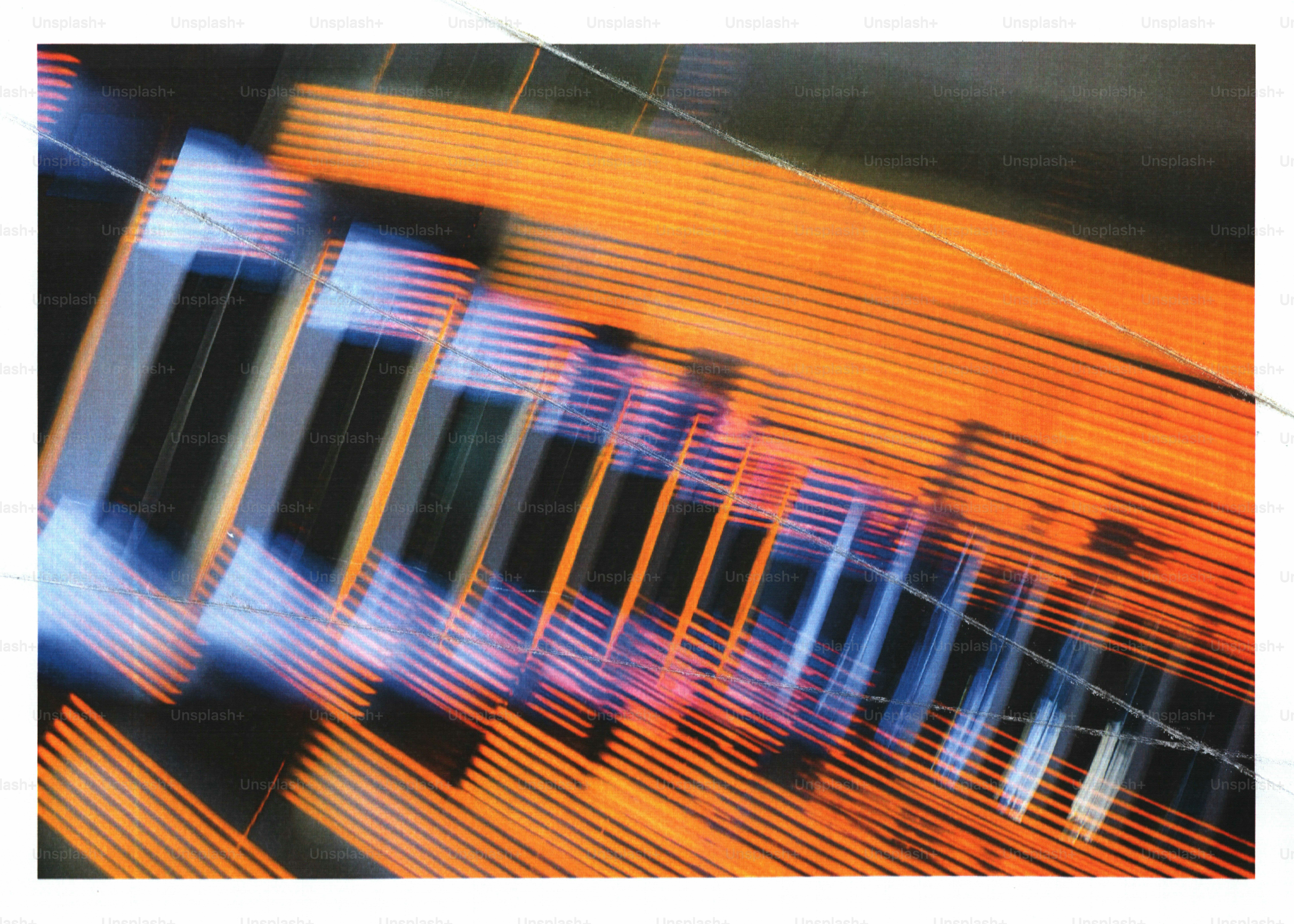 Motion blur of orange and blue light streaks against a dark background