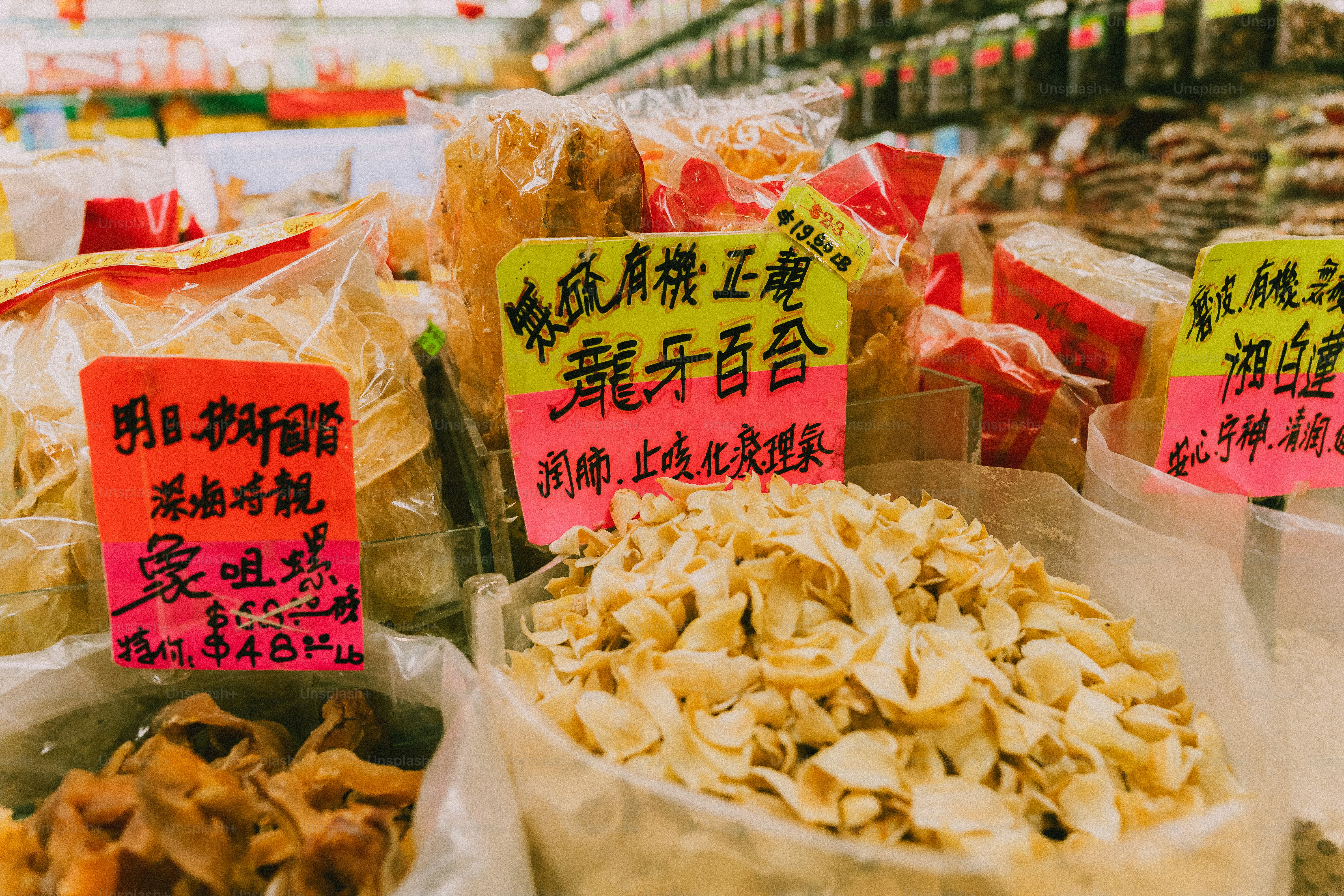 Dried food products in plastic bags with handwritten price tags in a market