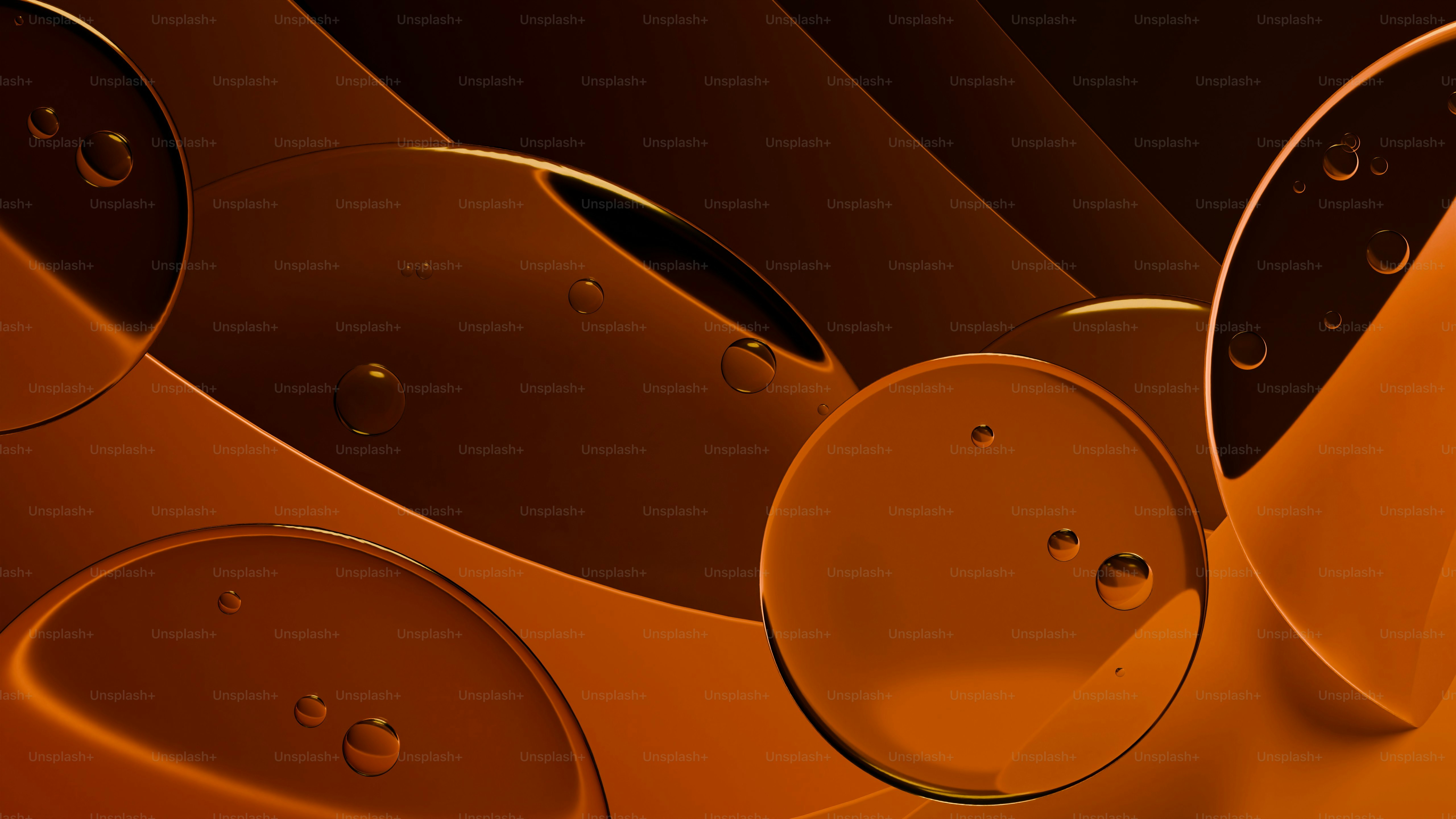 Clear liquid droplets on smooth, overlapping amber-colored circular surfaces