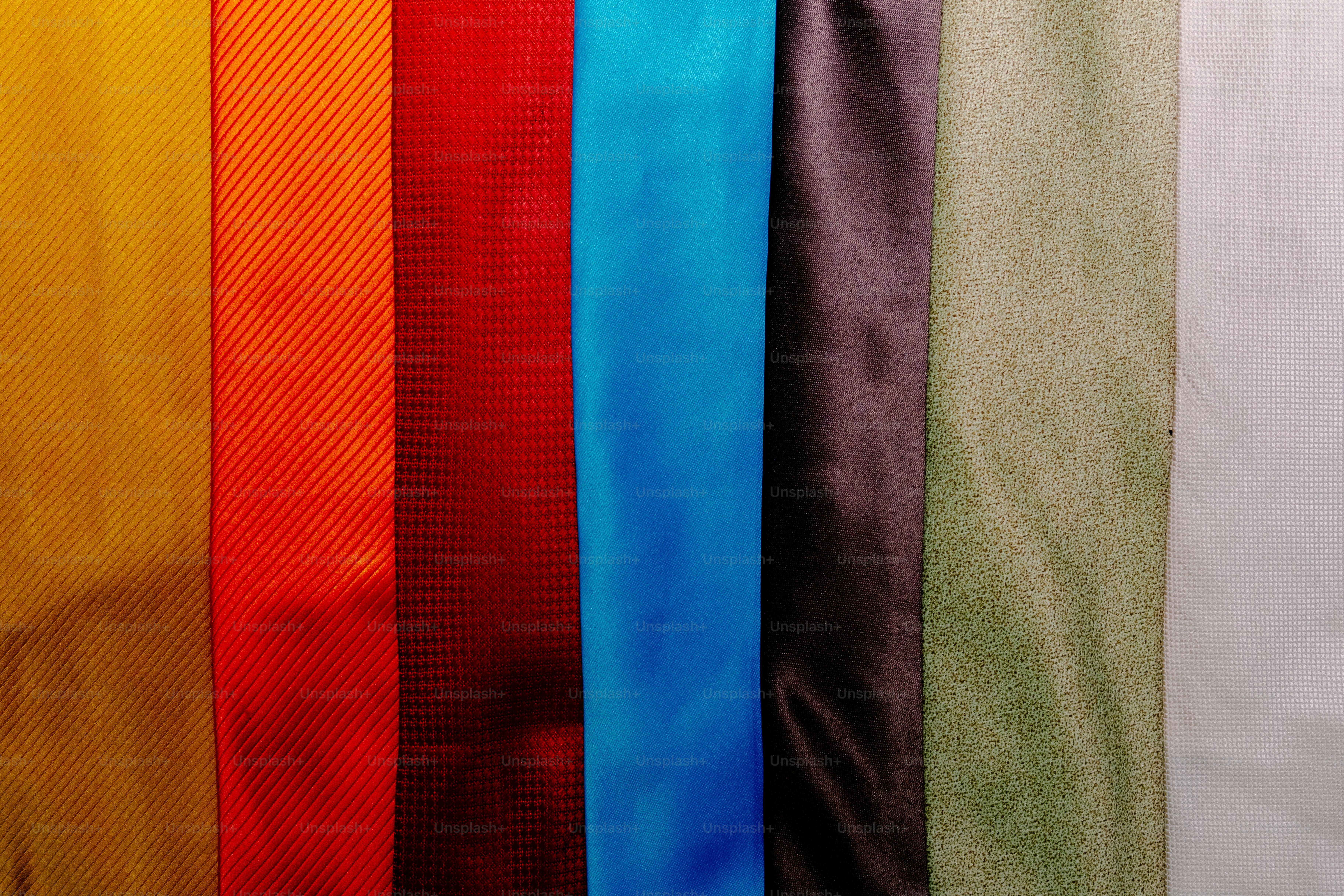 Seven vertical fabric strips in yellow, orange, red, blue, brown, green, and white