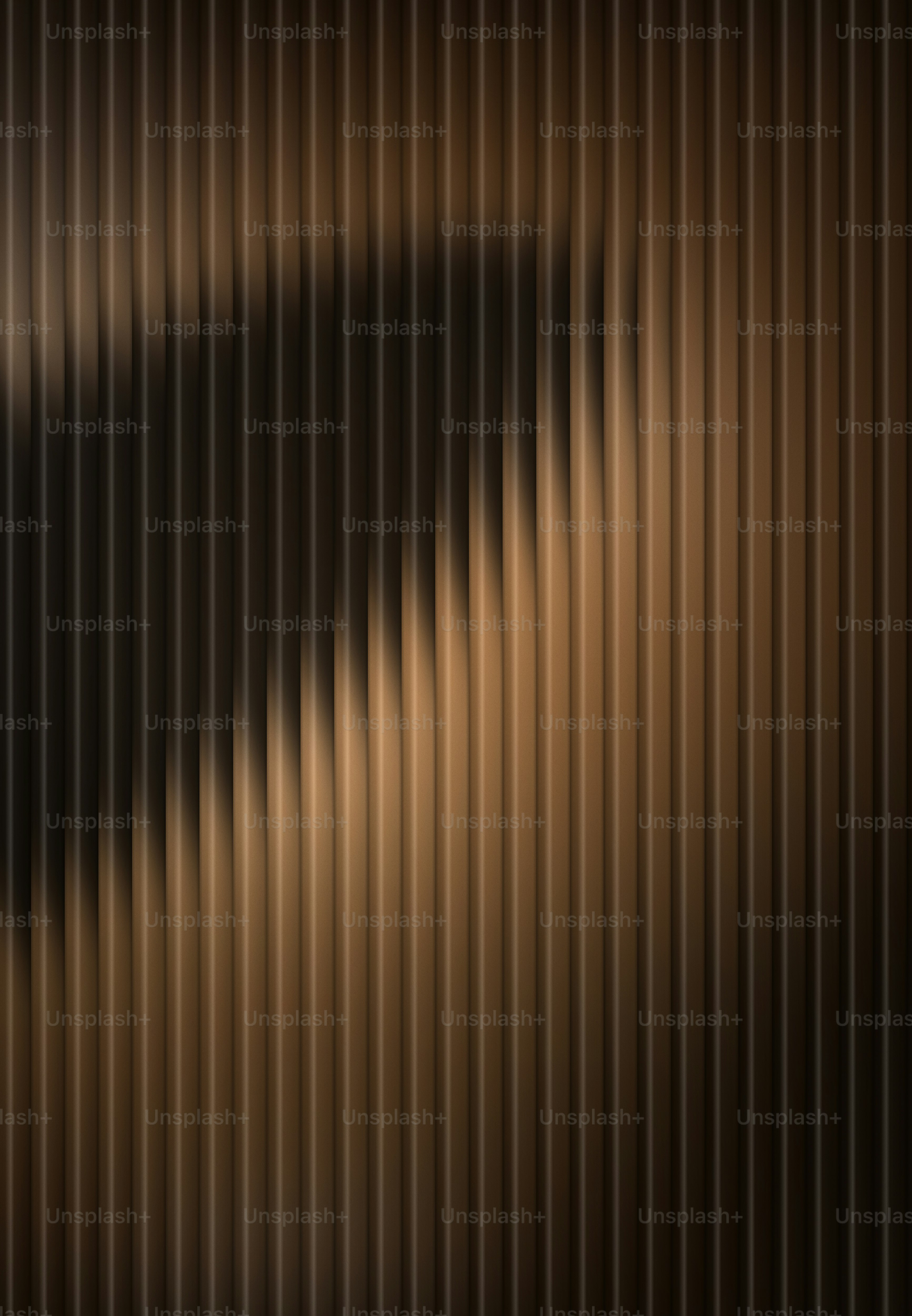 Vertical brown fluted panels with a soft shadow cast across the textured surface.