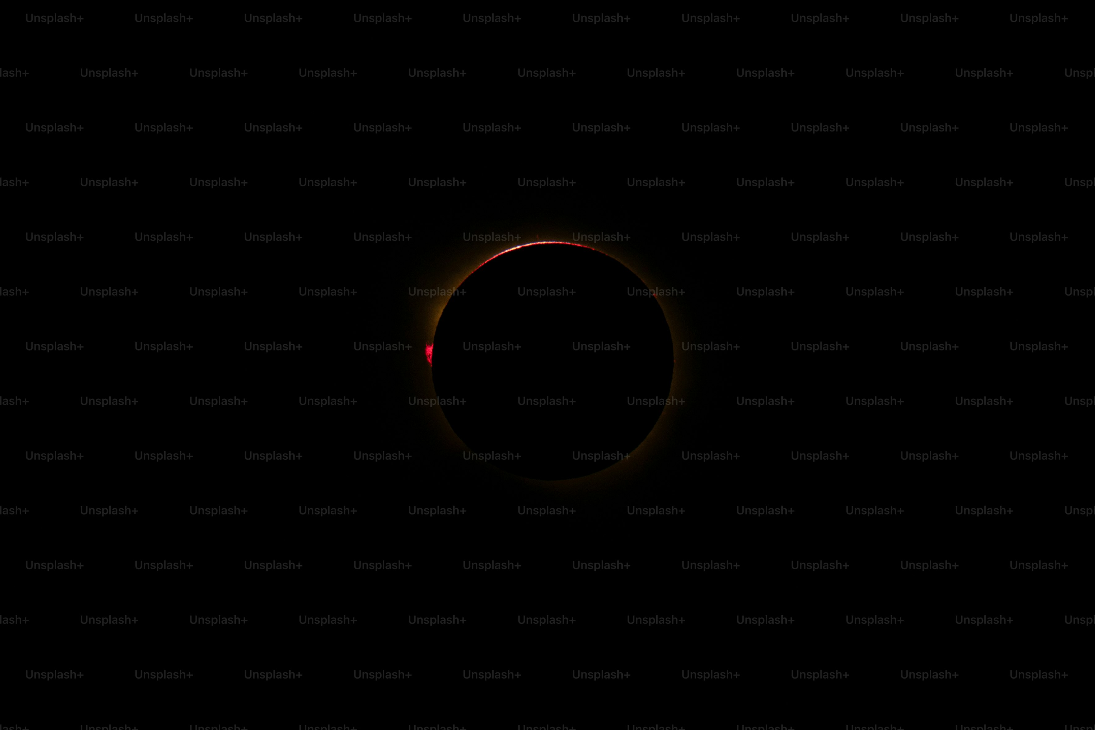 A total solar eclipse with a glowing corona against a dark sky