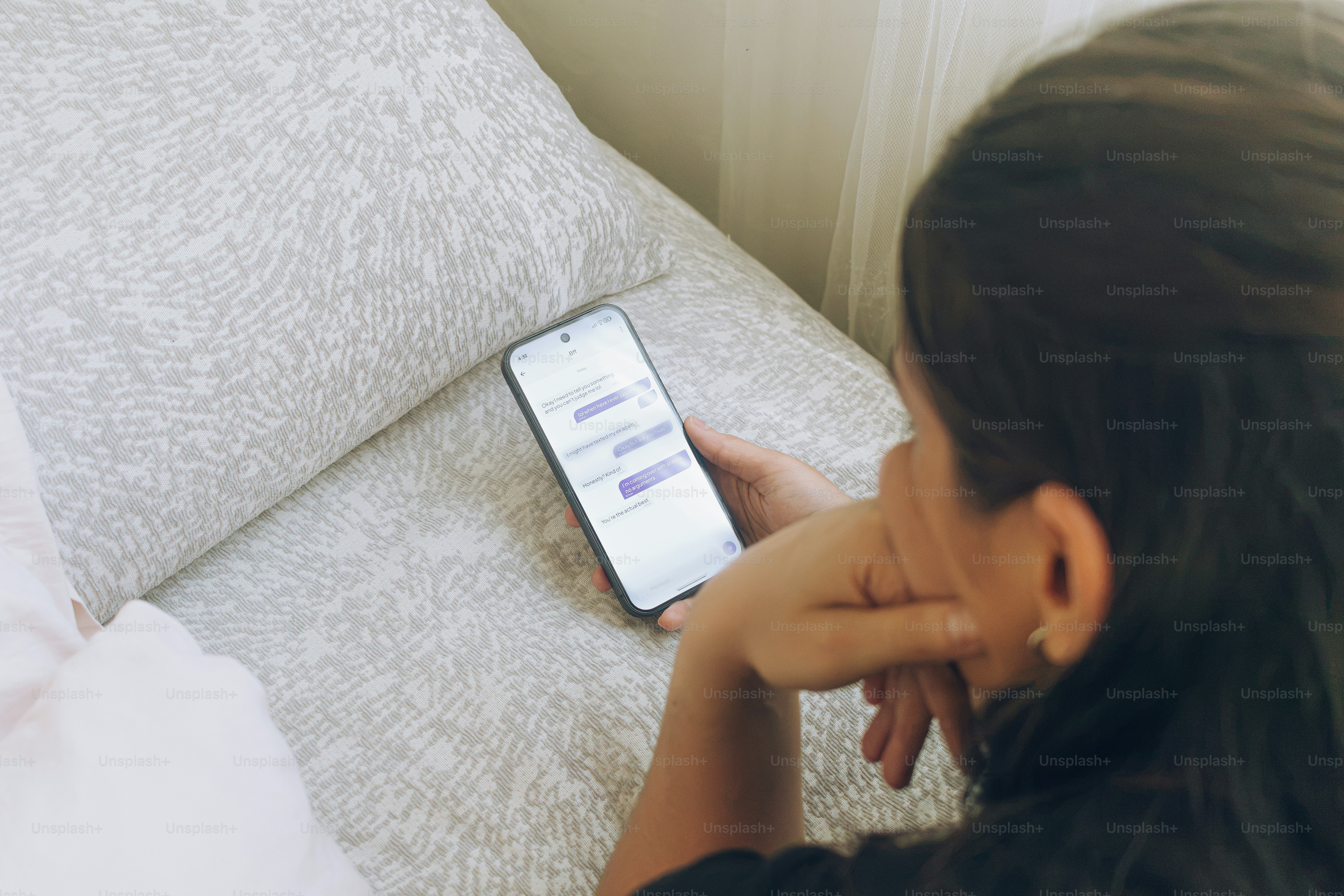 Person holding smartphone with text messages - Photo on Unsplash+