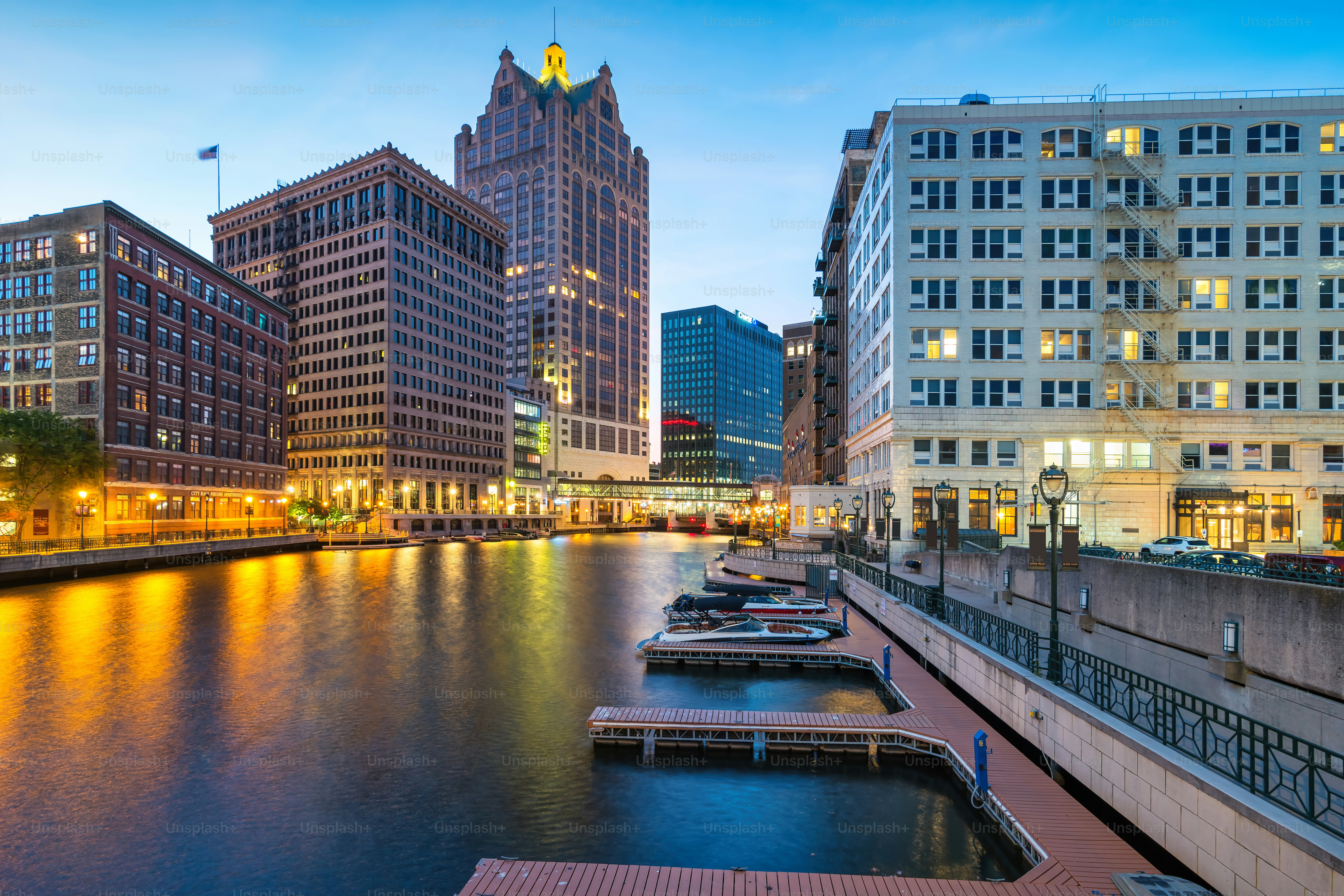 Downtown Milwaukee, Wisconsin, USA with the Milwaukee River and Milwaukee Riverwalk at twilight blue hour.