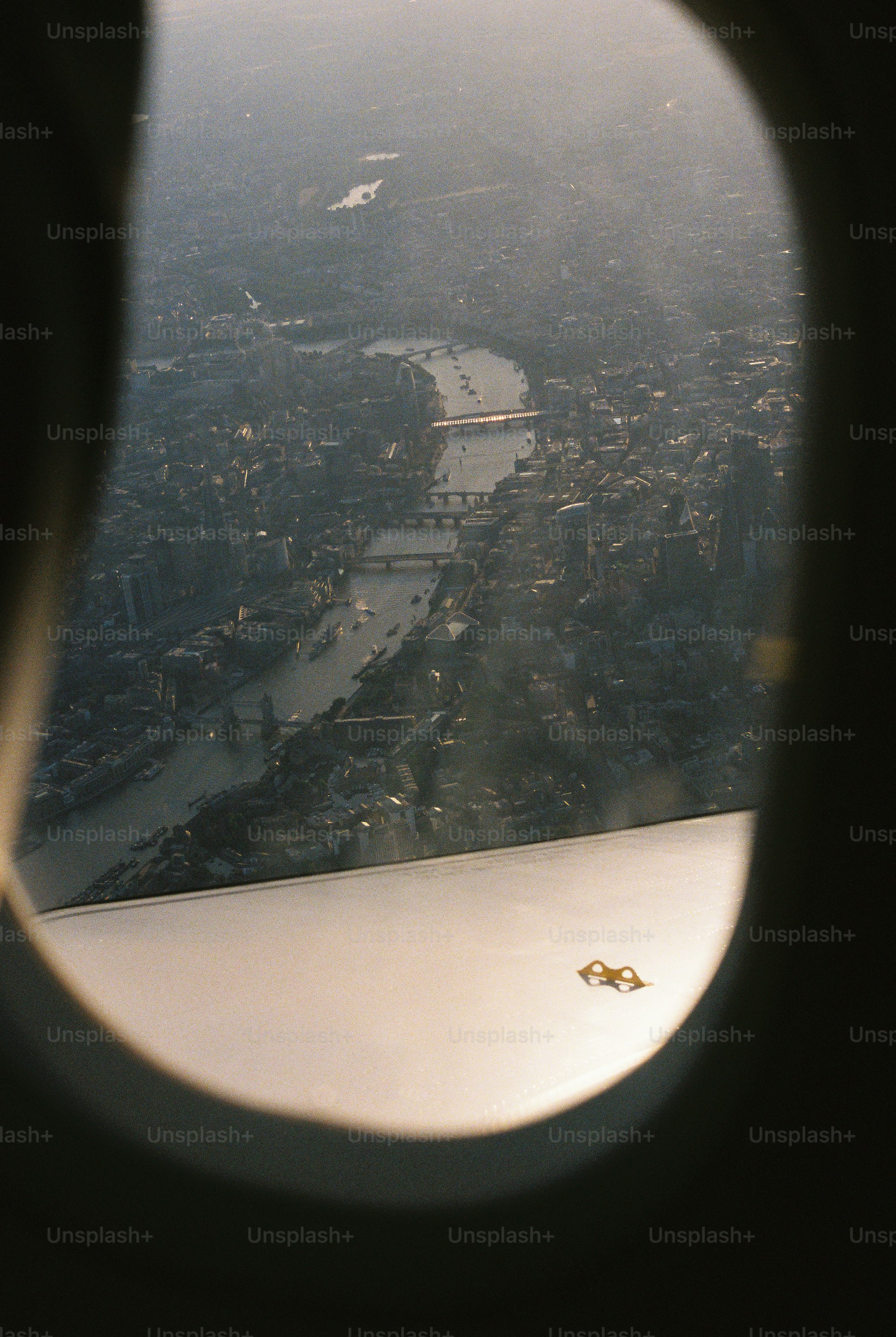 Aerial view of the River Thames winding through London seen from an airplane window
