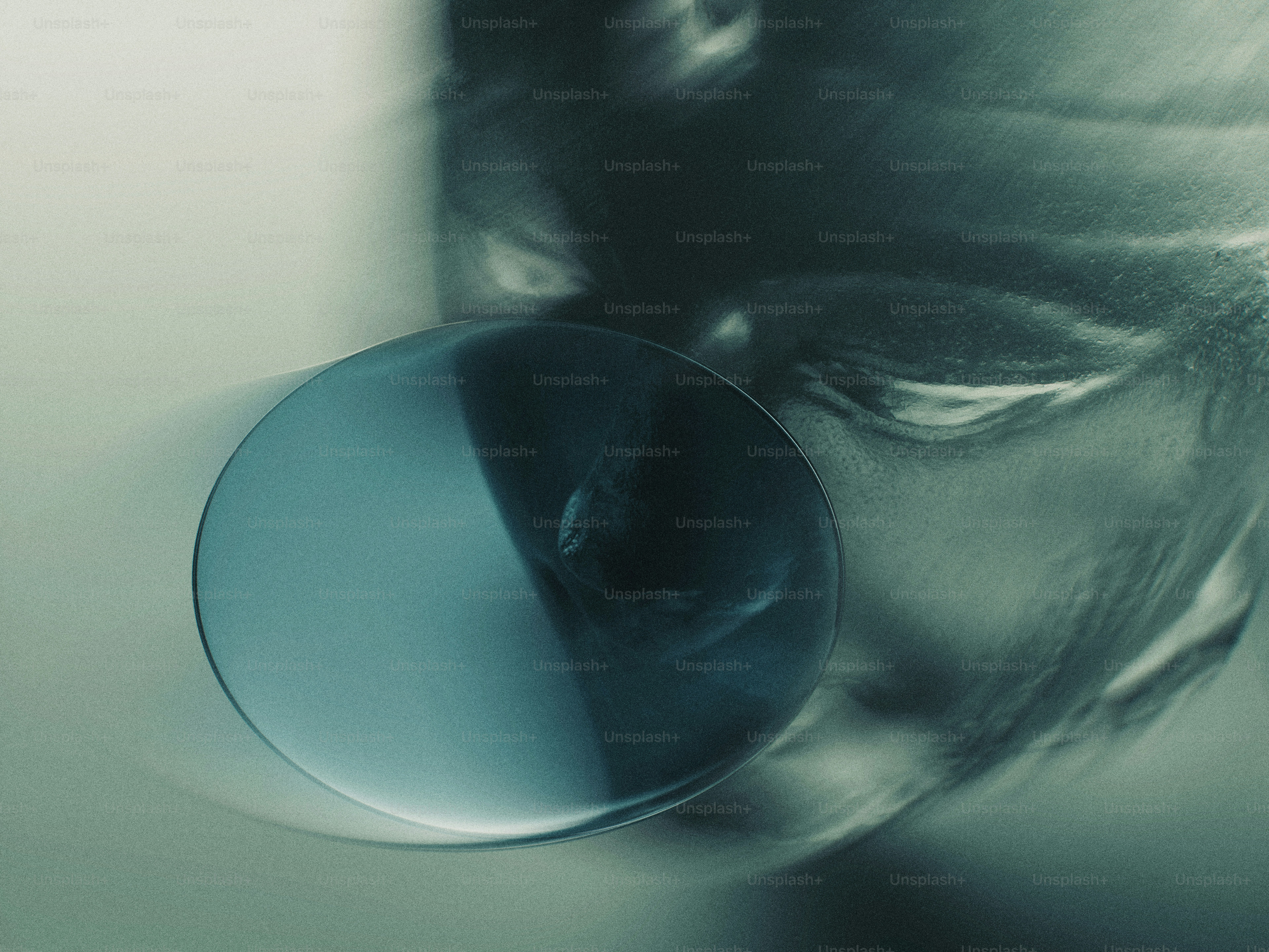 A circular blue lens magnifying a blurred face in a dark moody atmosphere