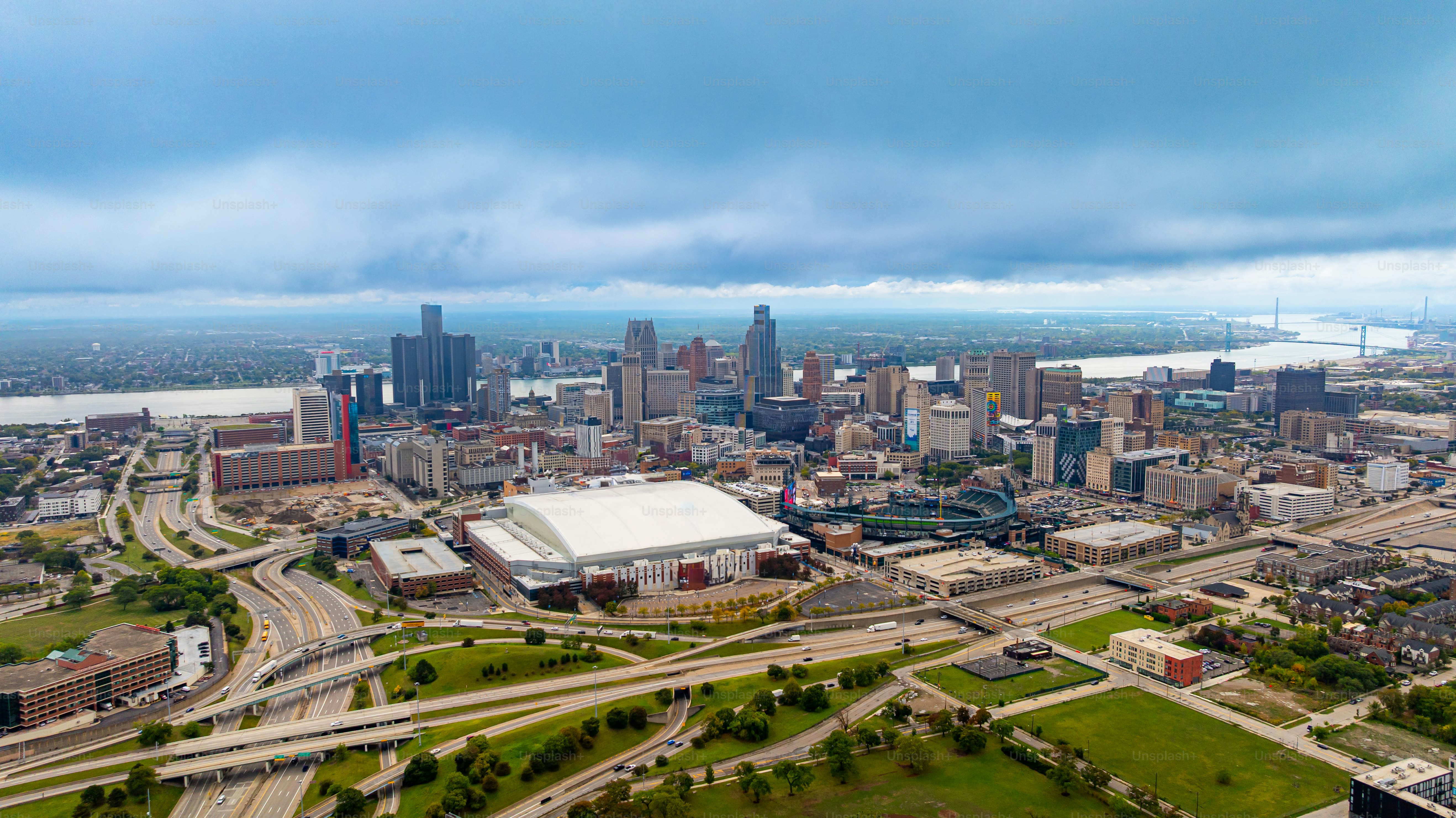Aerial panoramic view of Detroit skyline and highways. Detroit downtown skyline with highways and the Detroit River.