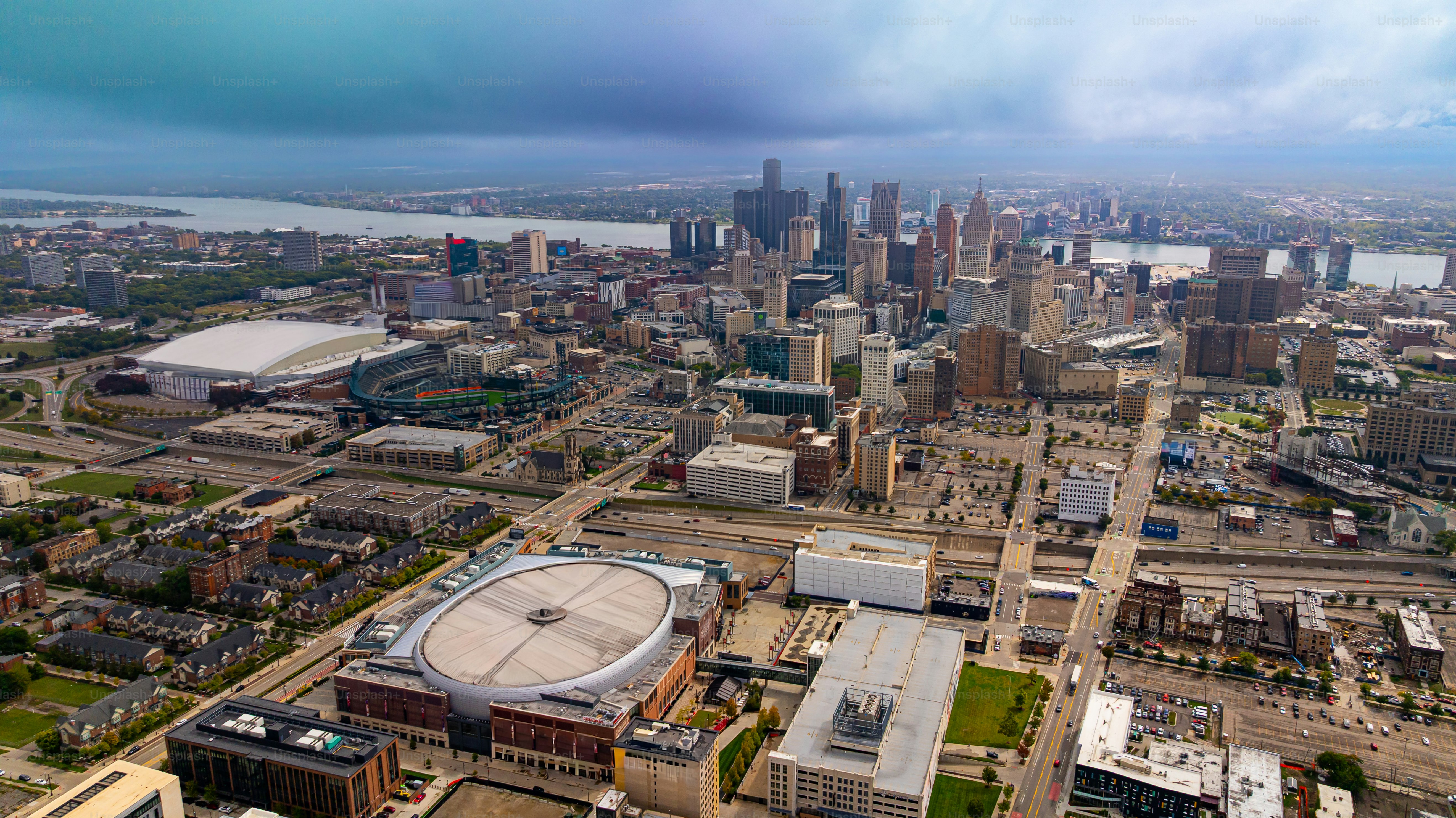 Detroit downtown aerial photo with stadiums and skyline. Downtown Detroit with major sports arenas and skyscrapers near the river.
