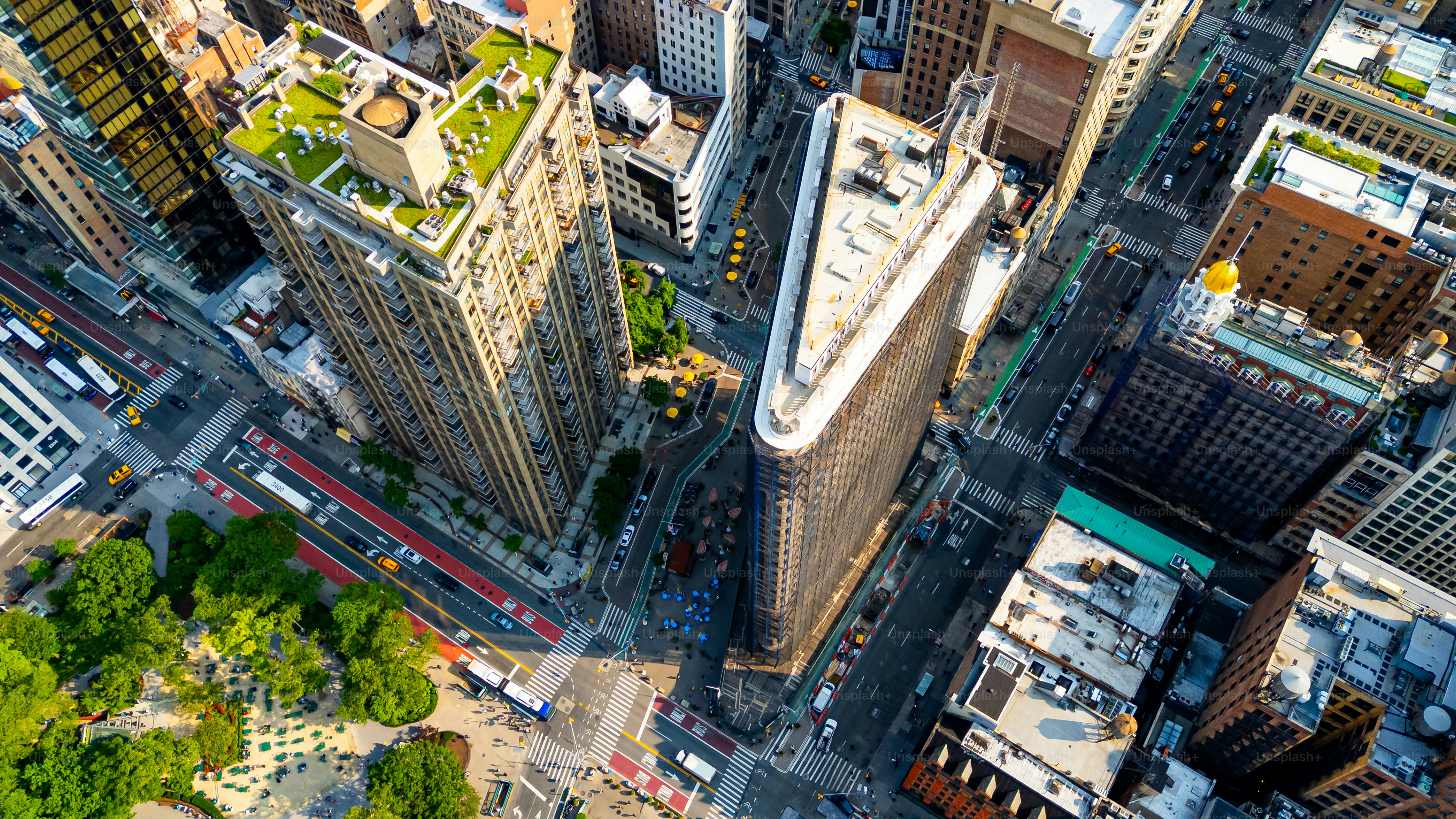 Aerial top view of Flatiron Building and Manhattan streets. Drone aerial photo of the Flatiron Building and surrounding Manhattan streets in New York City.
