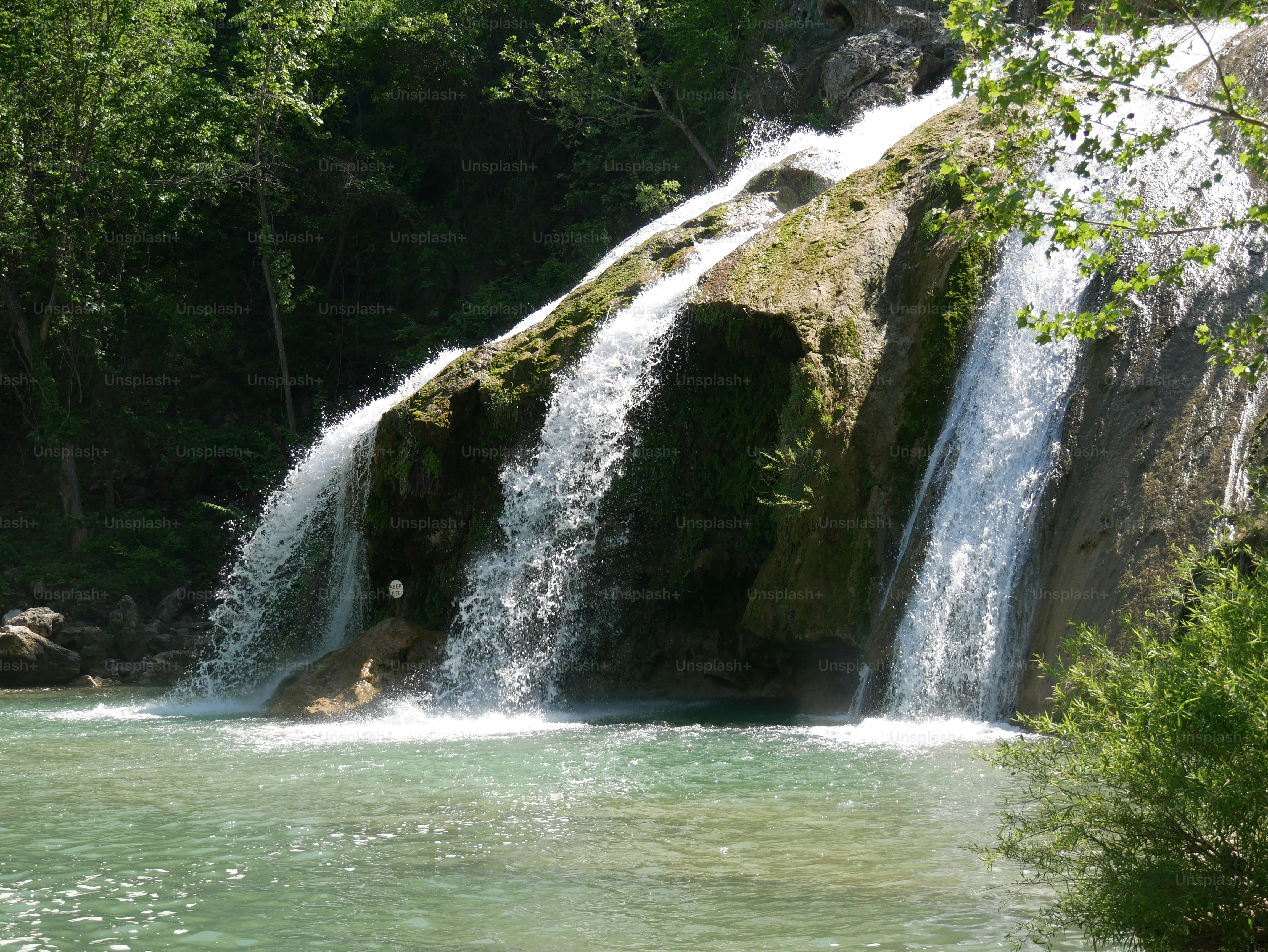 A side view of the waterfalls at Turner Falls Park in Honey Creek, Arbuckle Mountains.