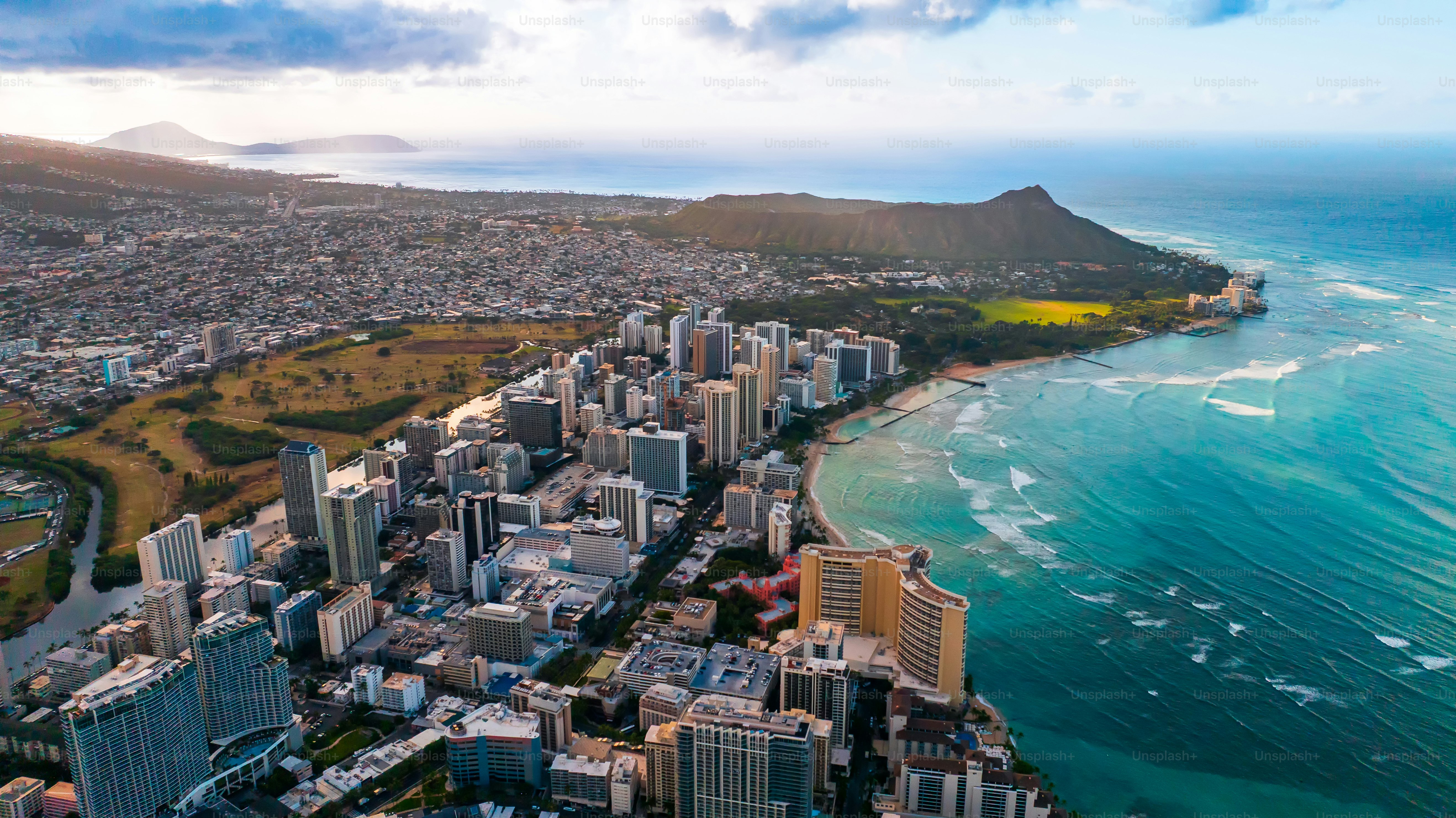 Beautiful panorama of Waikiki at the shore of the Pacific Ocean. Aerial perspective on the Diamond Head Crater and blue ocean waterscape.