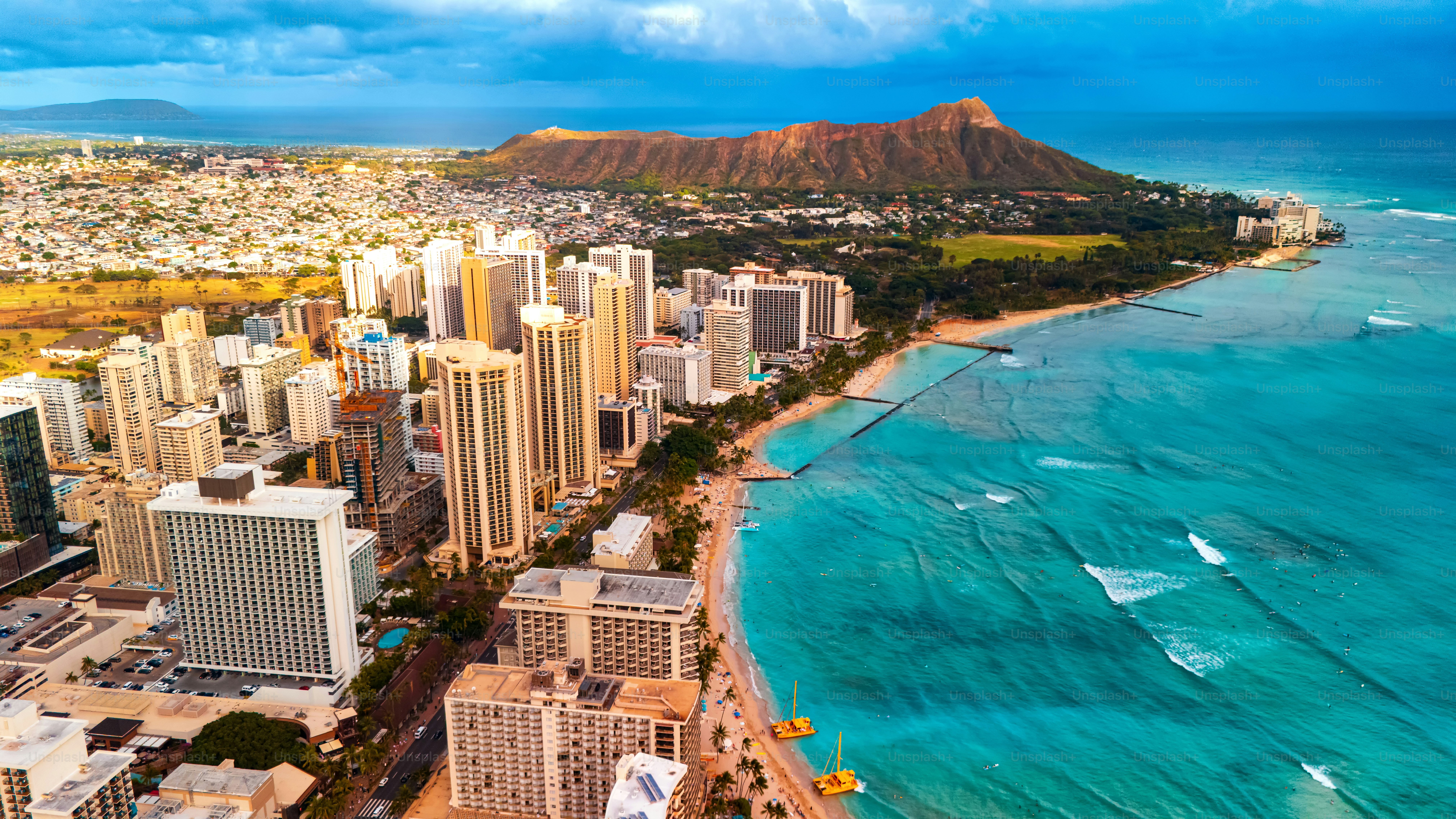 Beautiful panorama of Waikiki at the shore of the Pacific Ocean. Aerial perspective on the Diamond Head Crater and blue ocean waterscape.