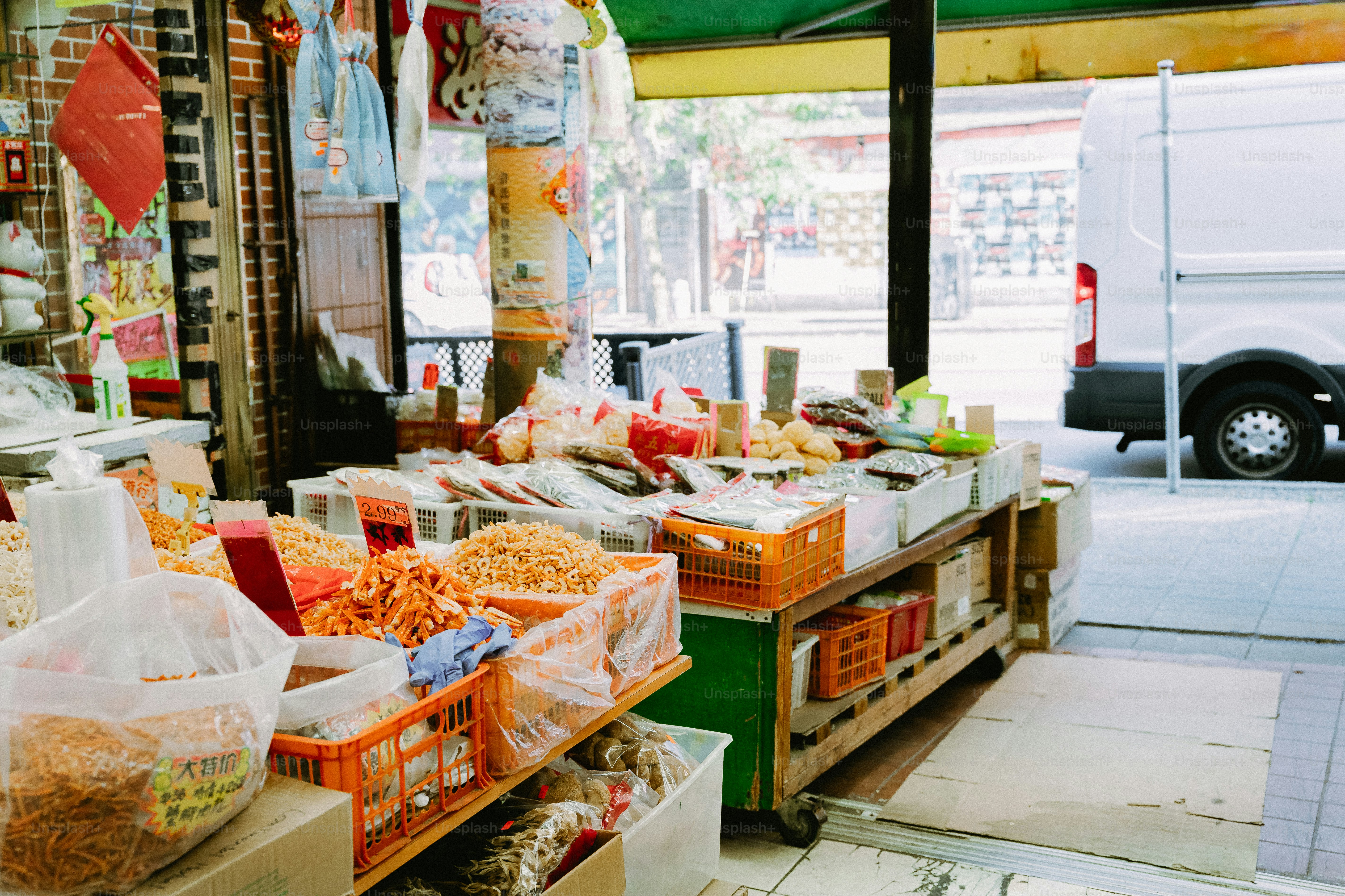 Getrocknete Meeresfrüchte und Snacks in Plastikkisten an einem Freiluft-Marktstand