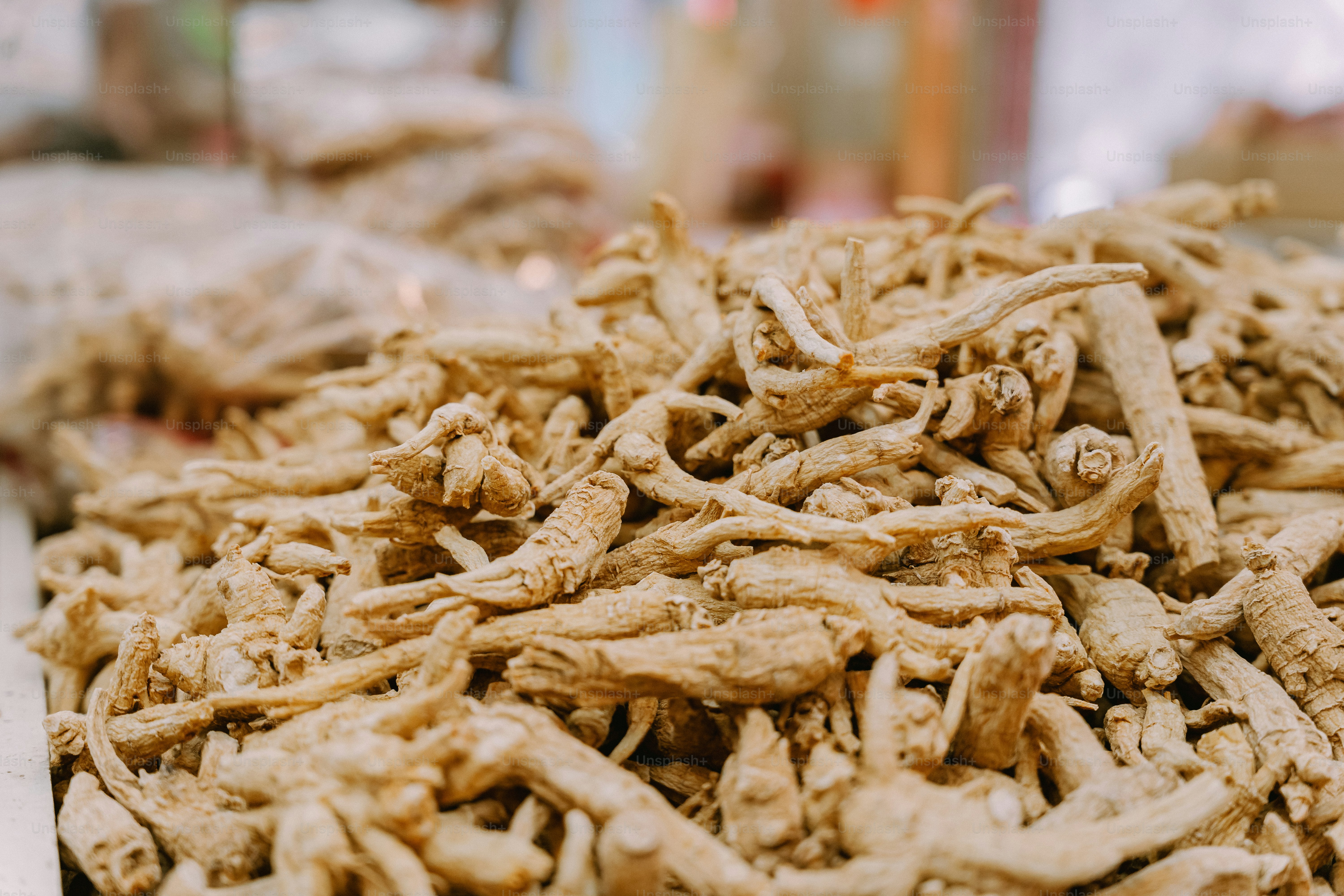 A large pile of dried ginseng roots on a market stall