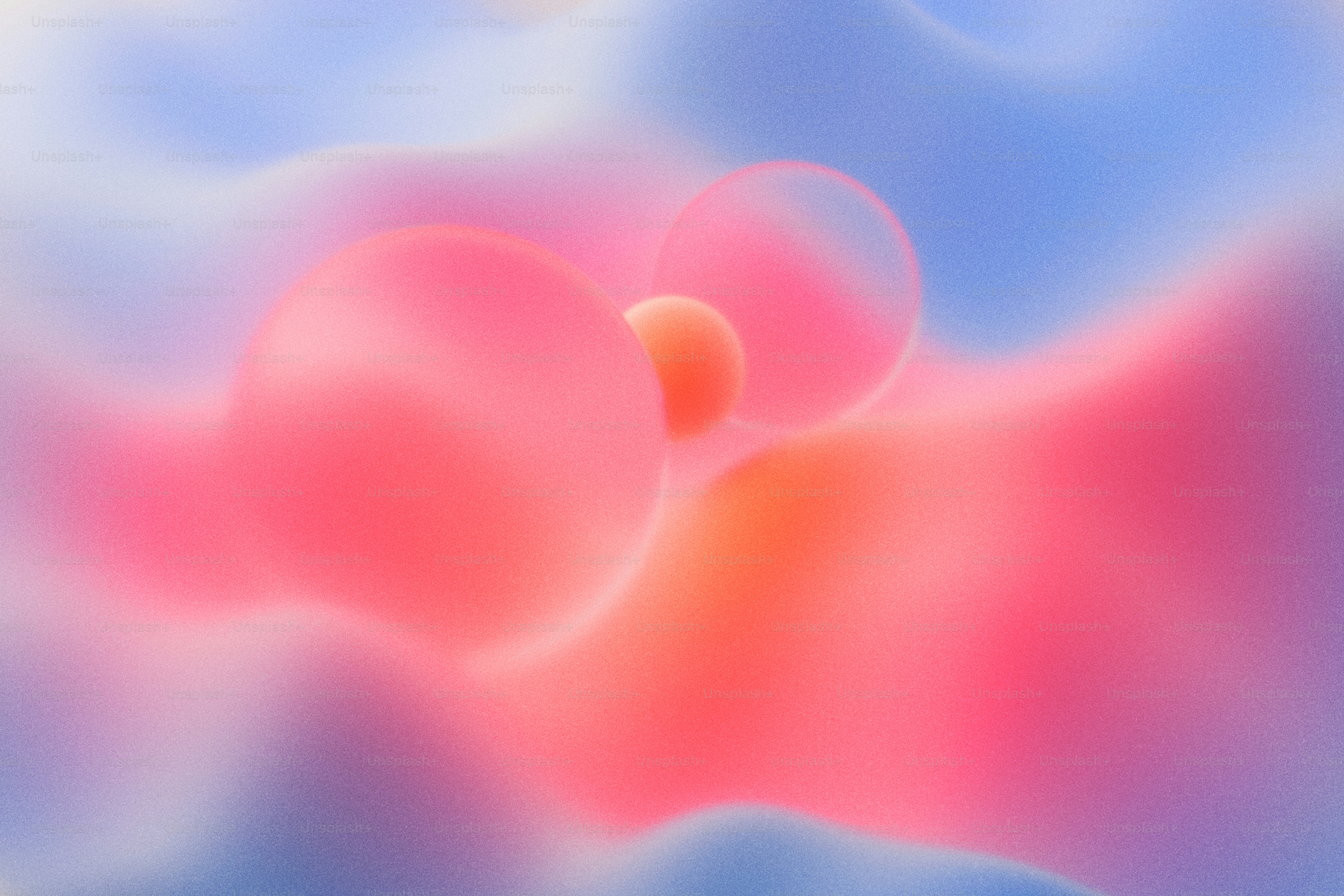 Abstract spheres in shades of pink and orange against a soft blue background