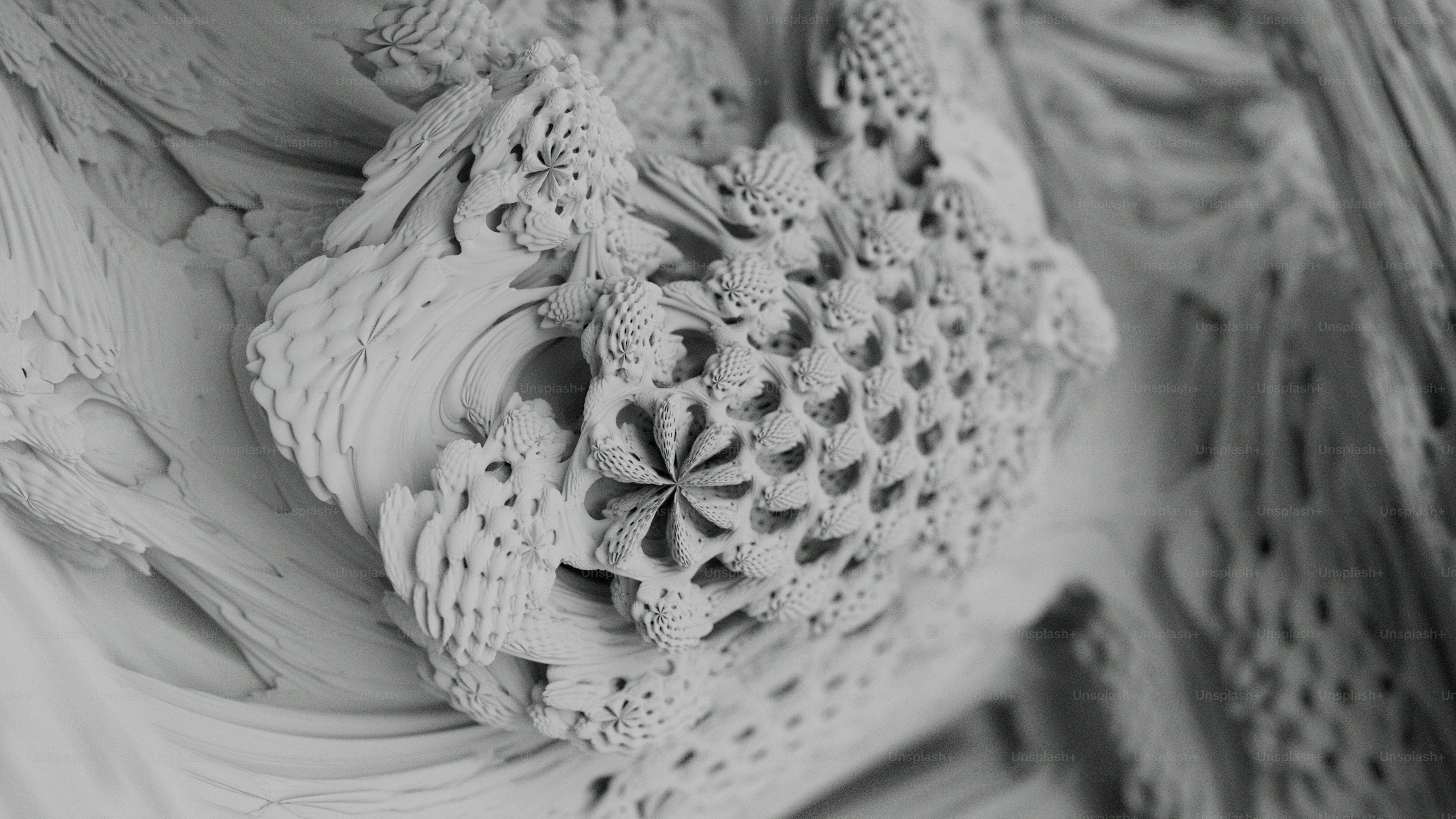 A complex fractal structure with intricate repeating floral patterns in shades of grey