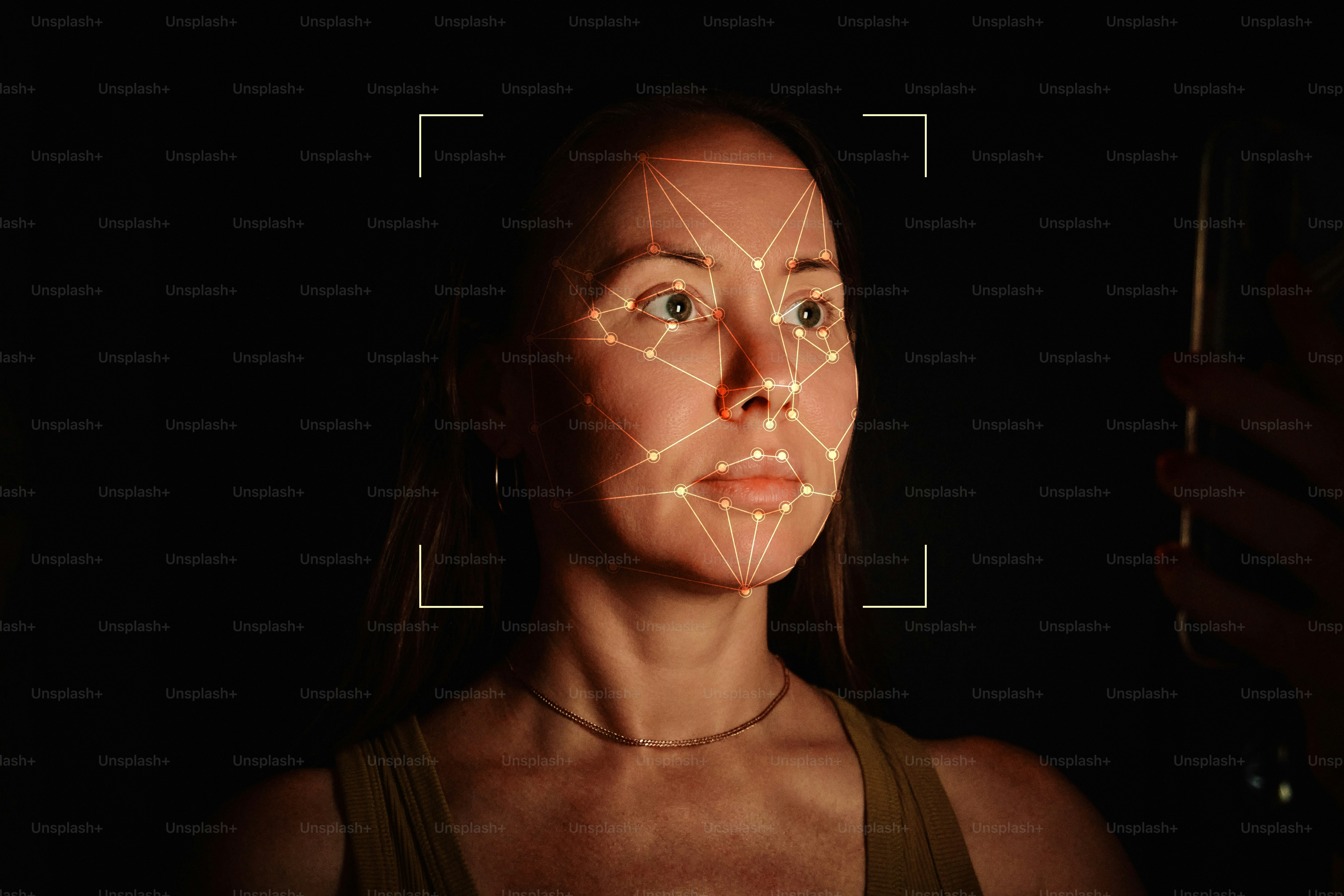 A woman with a digital facial recognition mesh overlay on her face