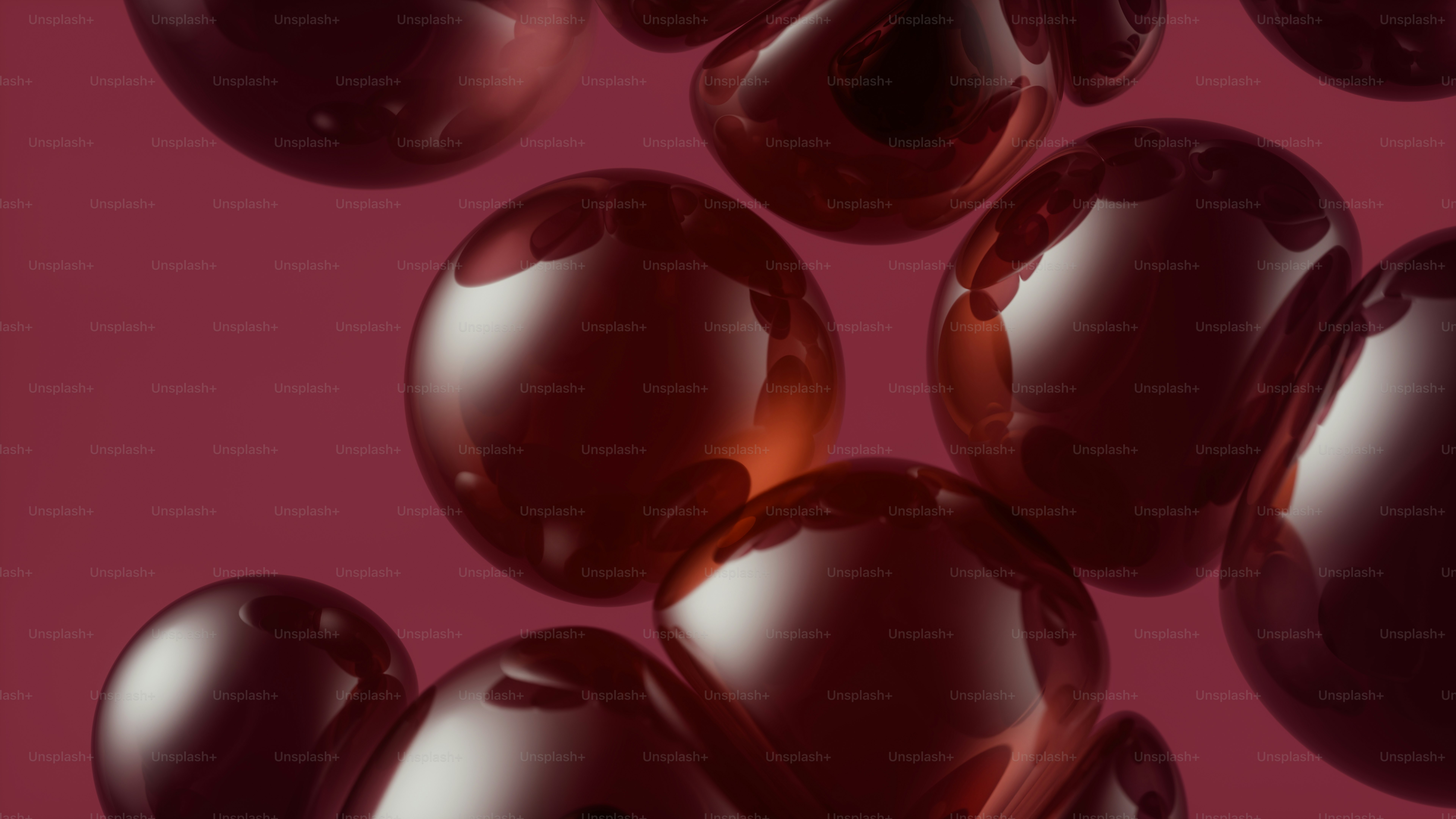 Glossy dark red spheres floating against a matching deep red background