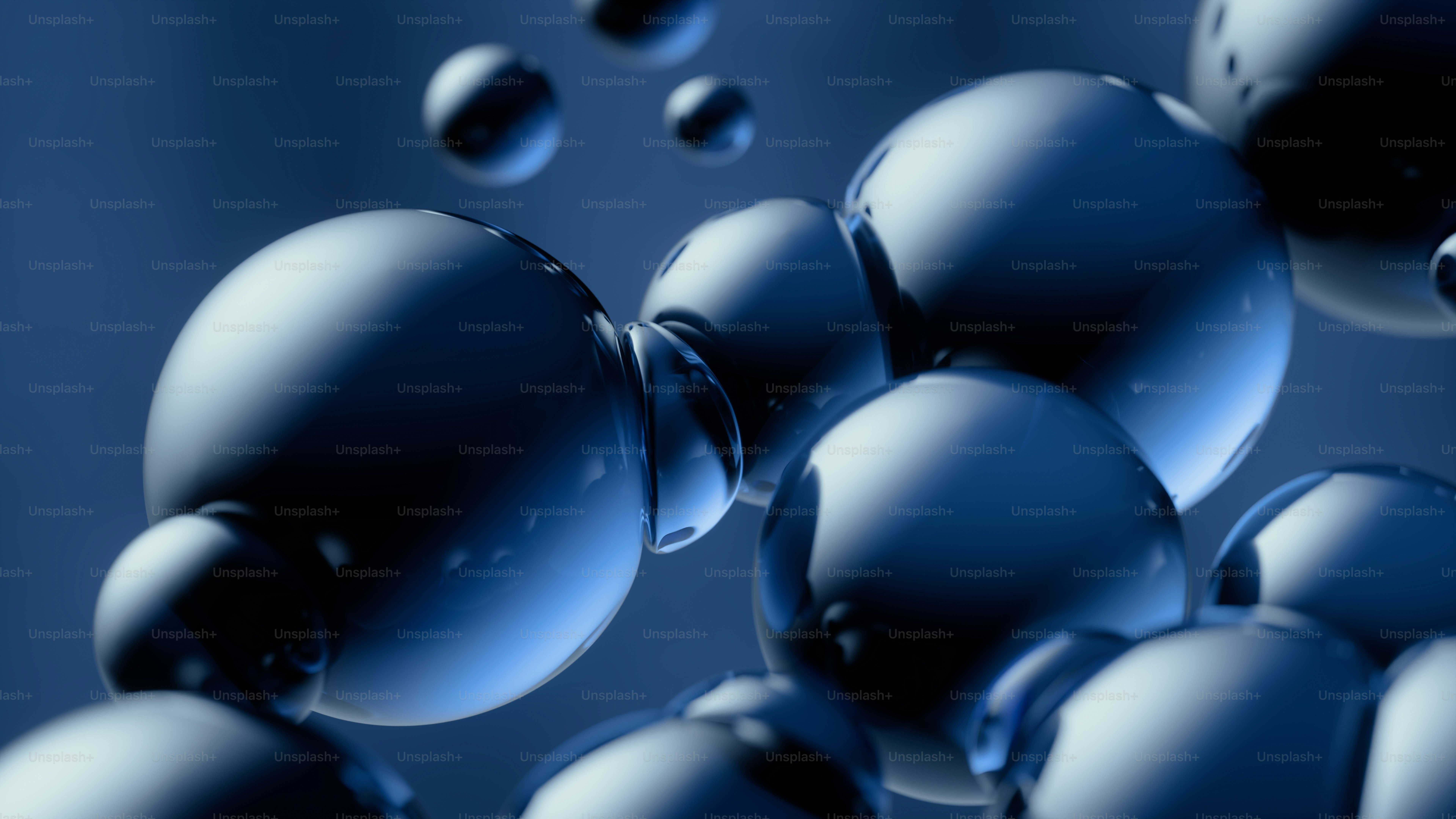 Glossy blue spheres of varying sizes floating against a dark blue background