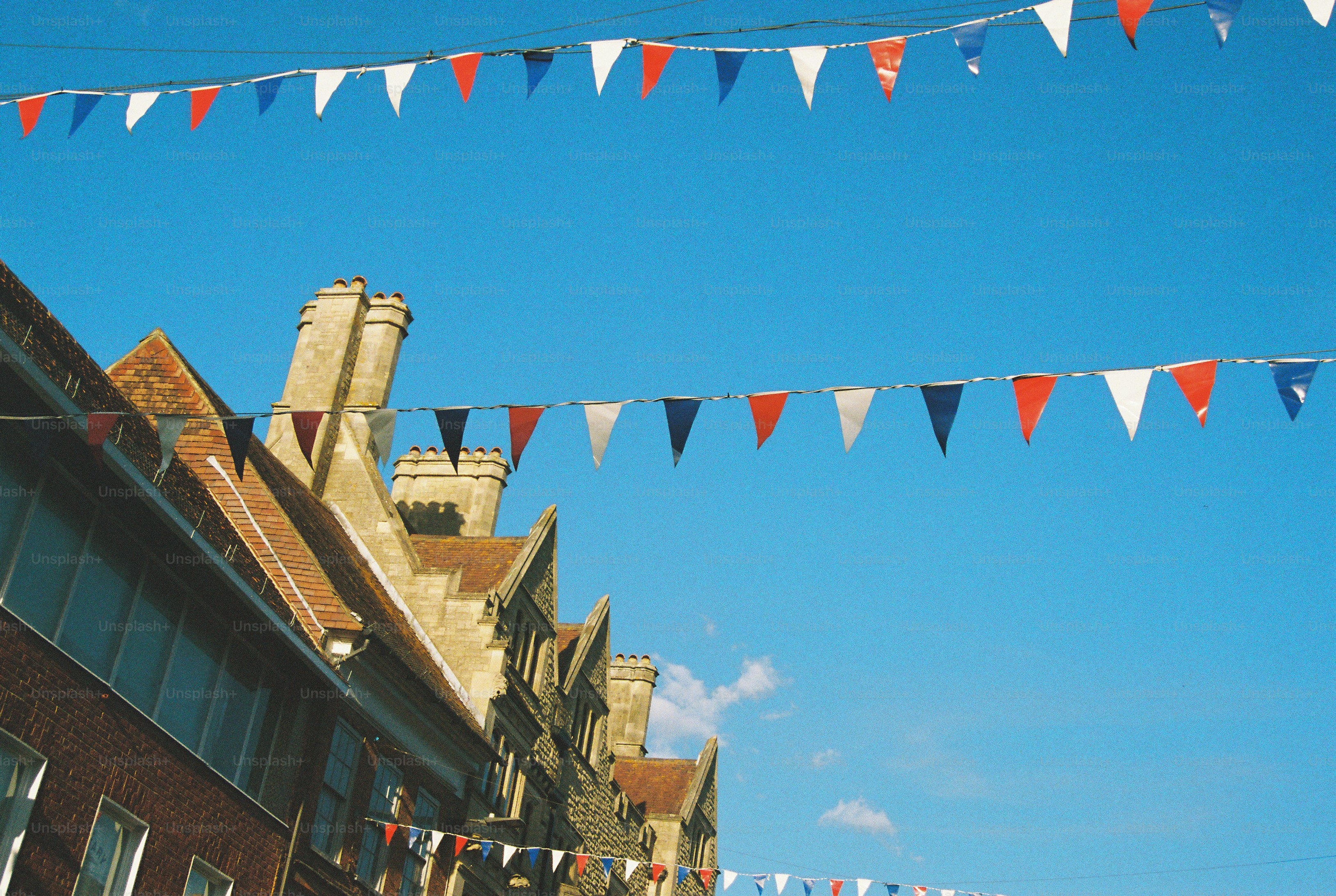 Red, white, and blue bunting flags strung across a clear blue sky