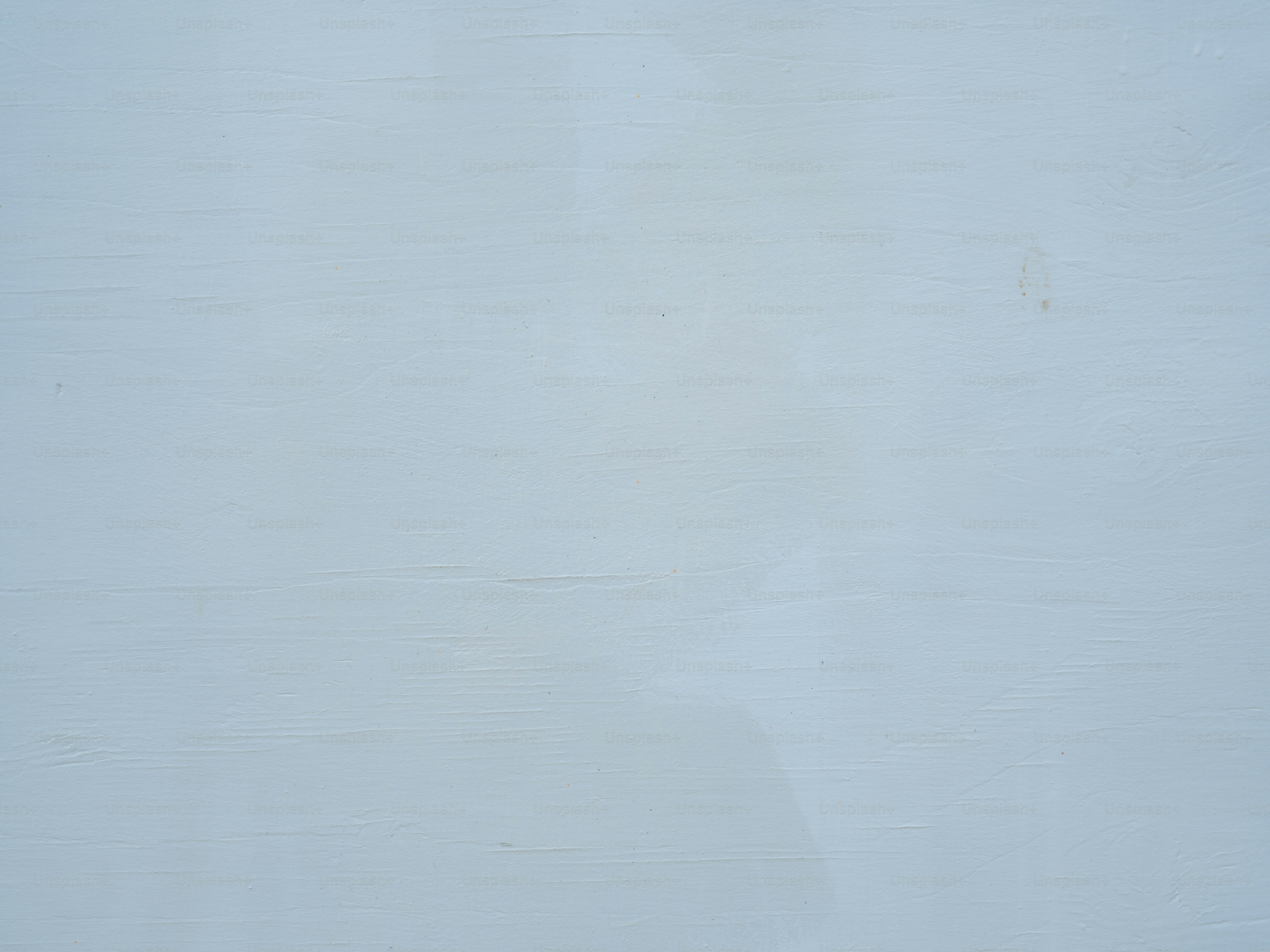 A pale blue painted wooden surface with visible horizontal grain and texture