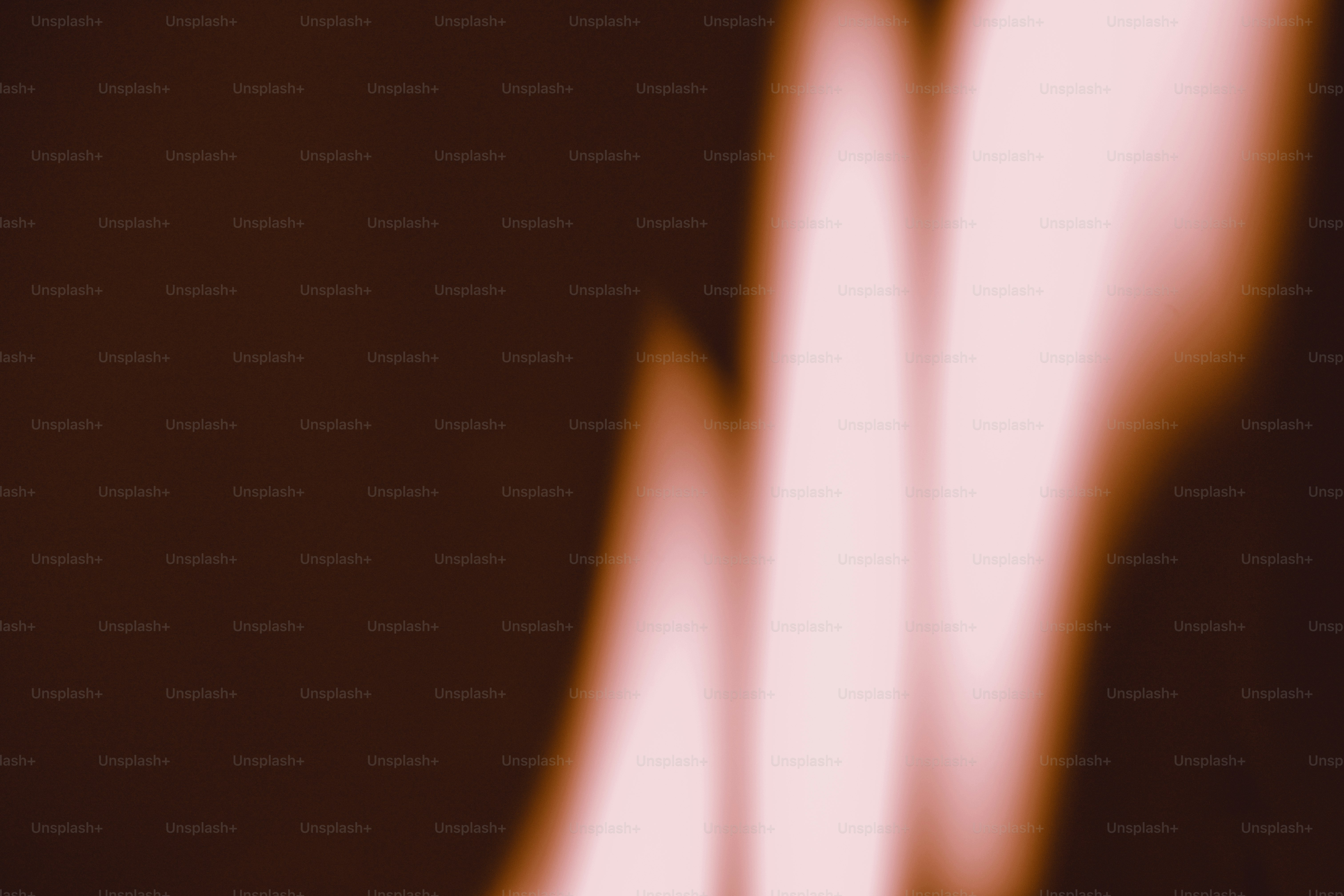Soft vertical streaks of pale pink light against a dark brown background