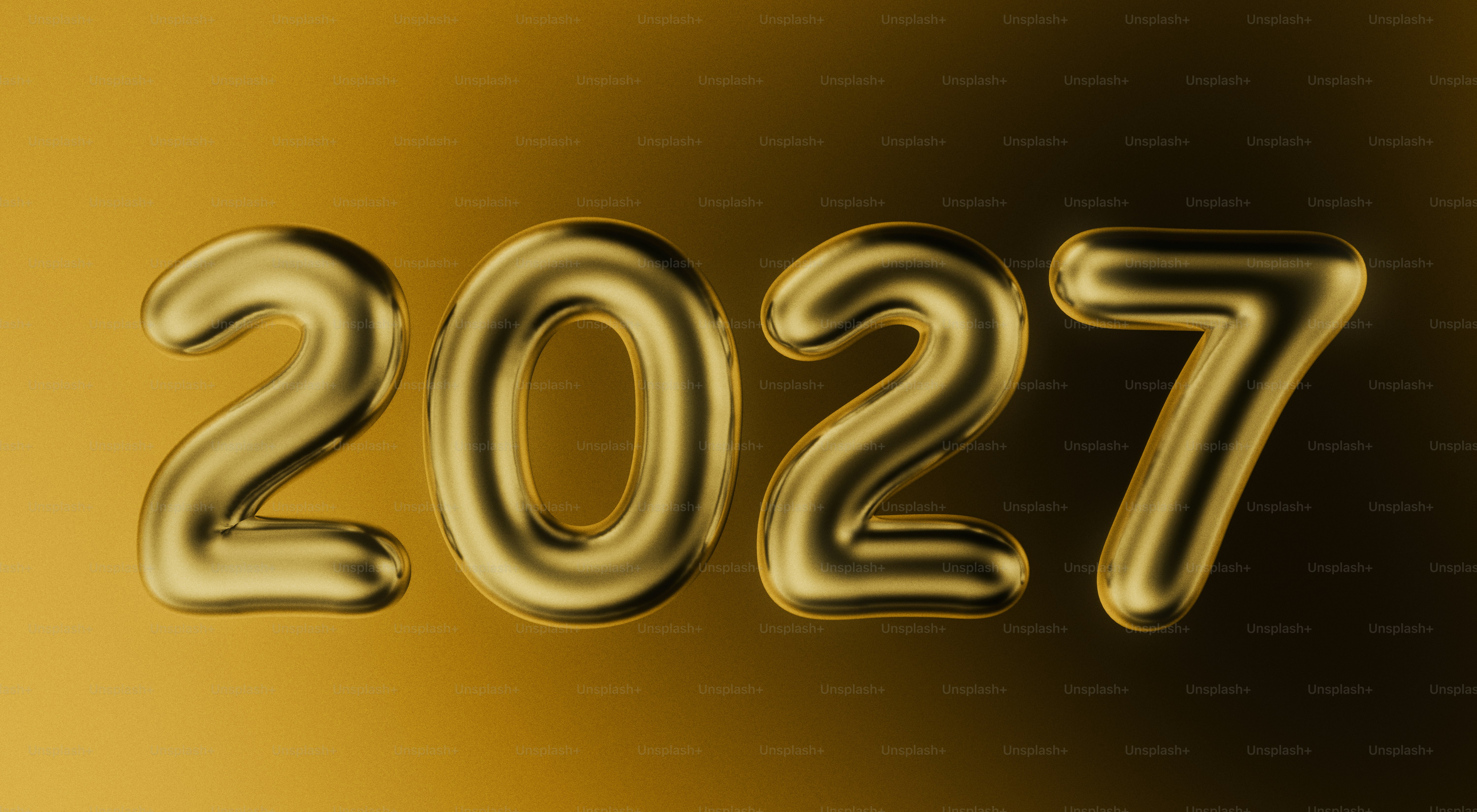 The number 2027 in large metallic gold balloon letters against a gold background