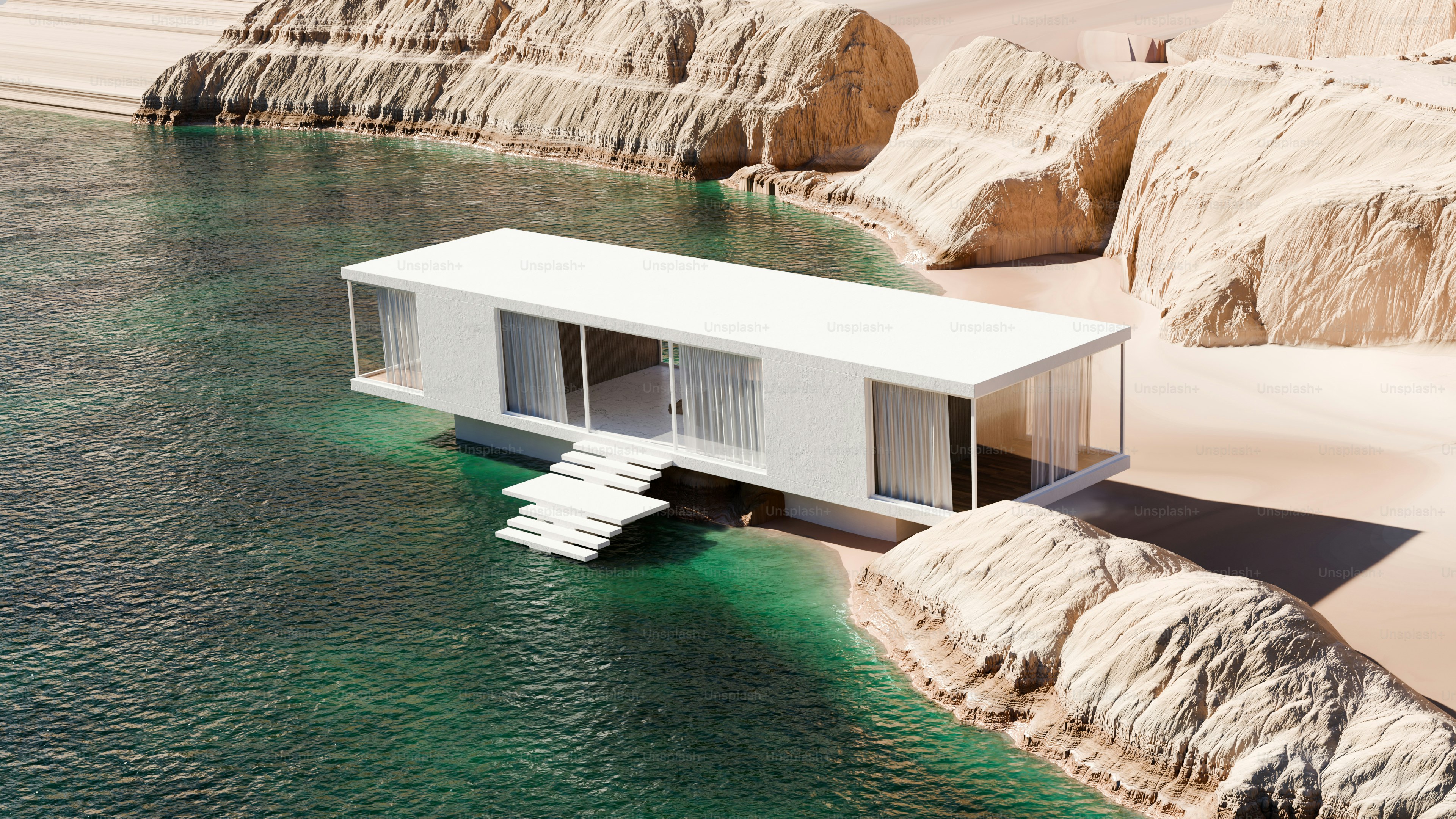 A modern white house on stilts above turquoise water near rocky cliffs