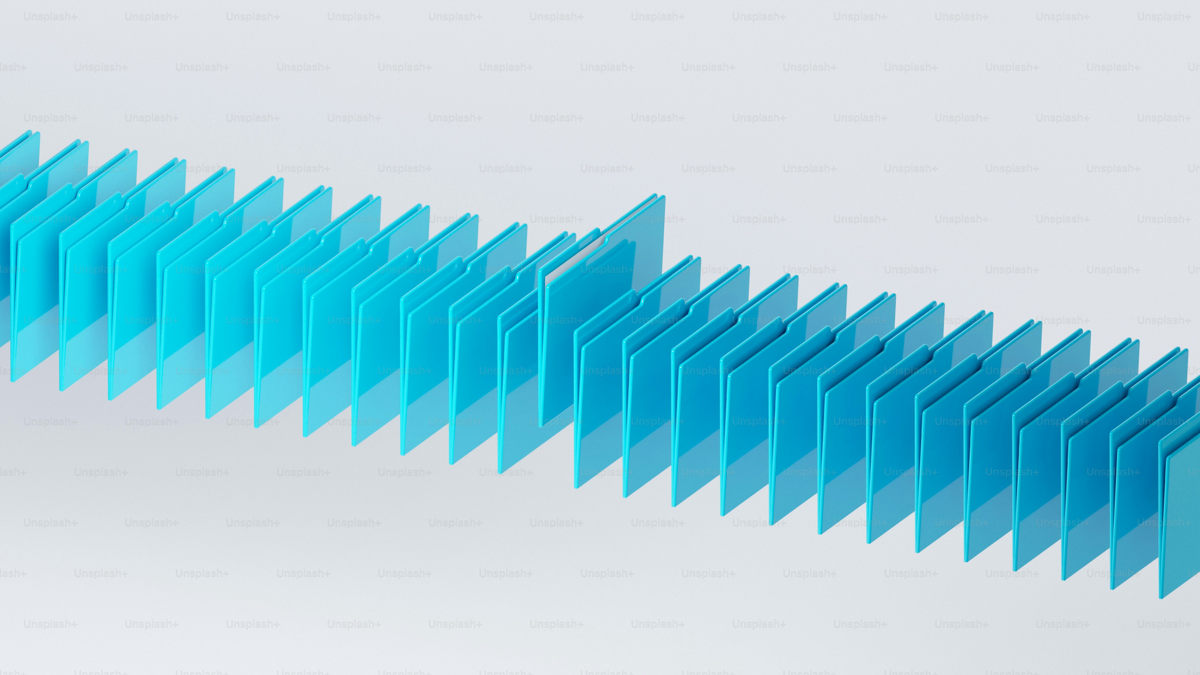 A row of bright blue file folders standing upright on a white surface