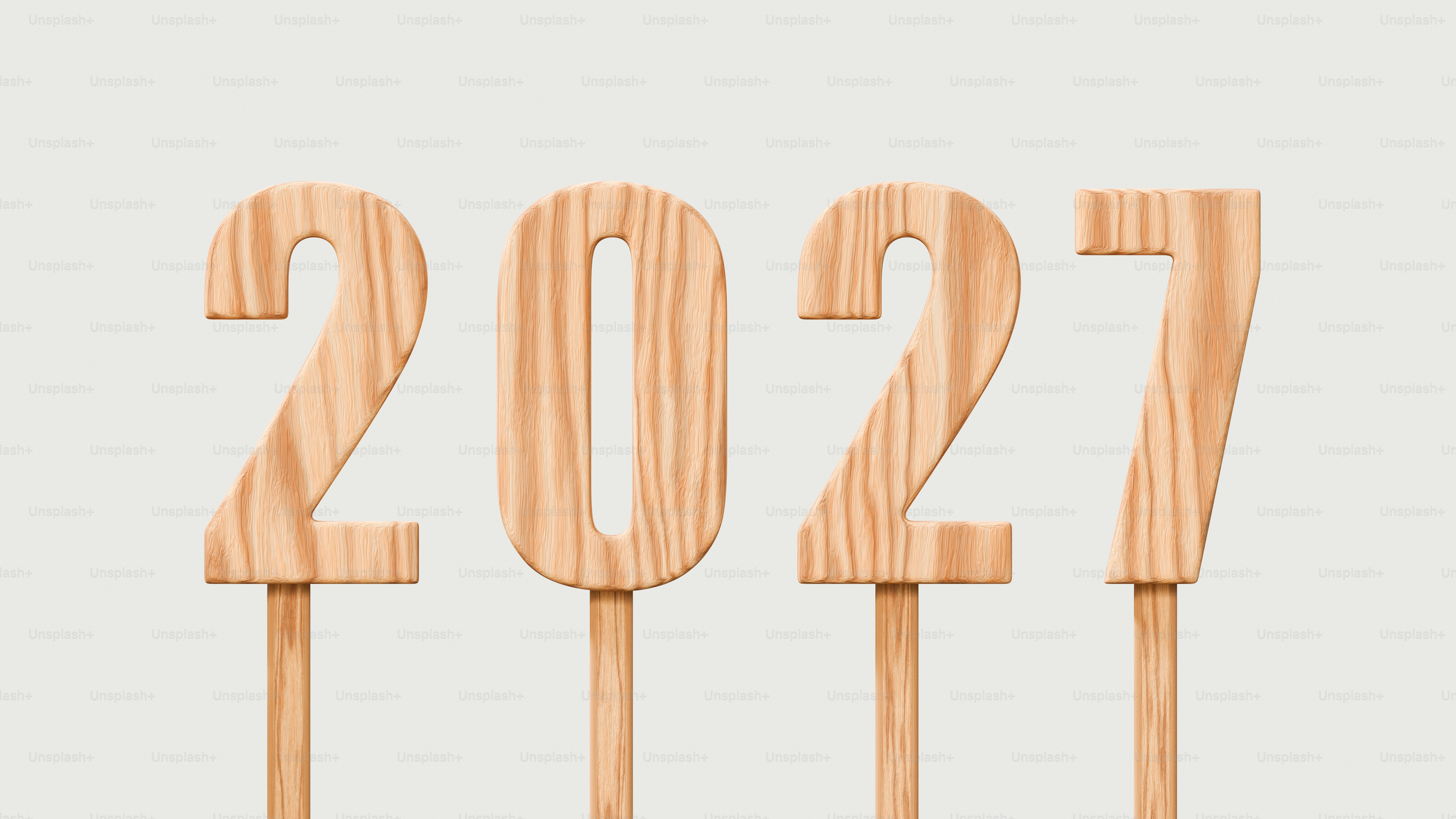 The numbers 2027 in light wood grain on individual sticks against a grey background