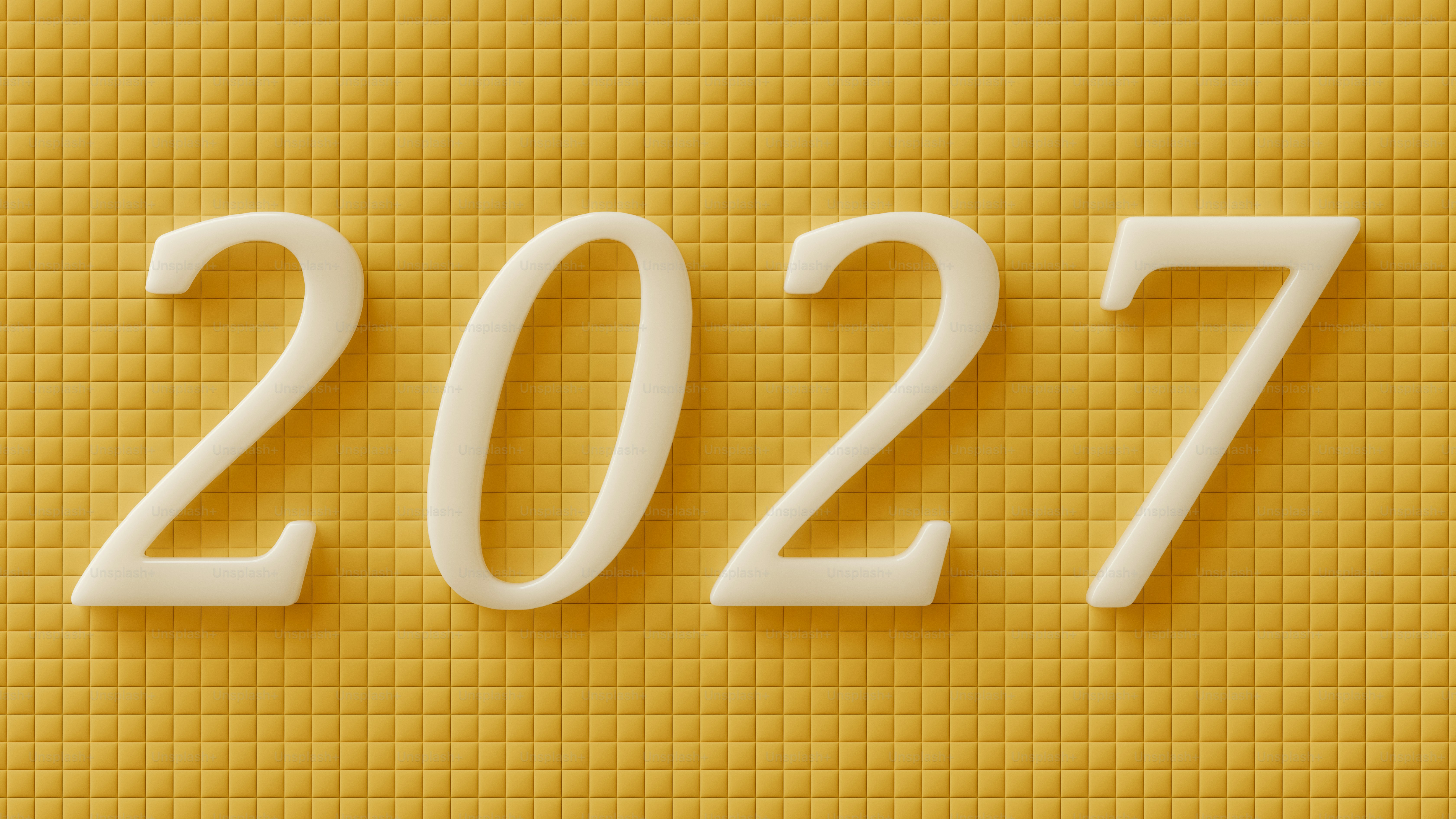 The number 2027 in white 3D digits on a yellow tiled background