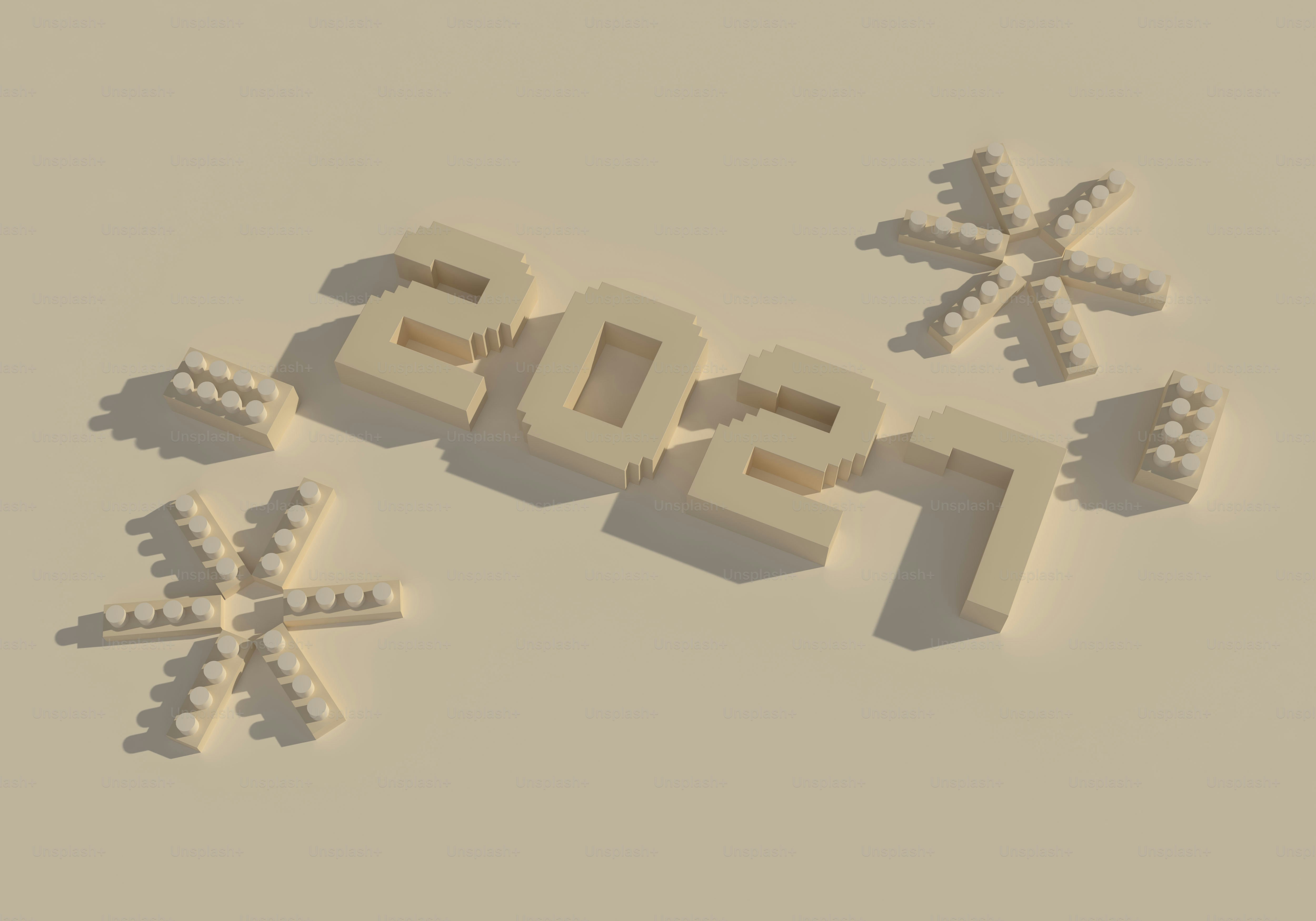 The number 2021 formed by beige blocks with two snowflake shapes on a surface