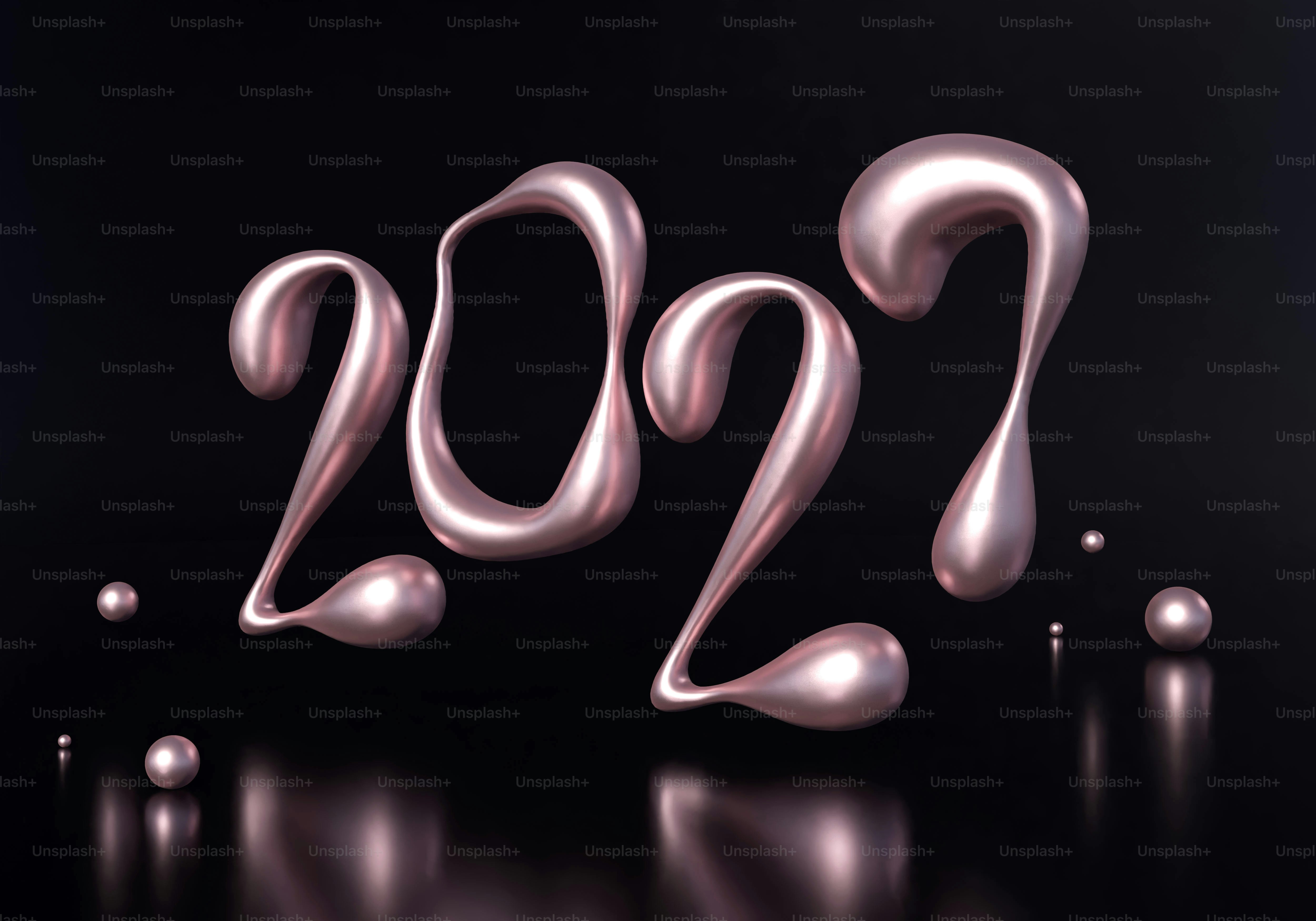 Metallic pink liquid numbers 2027 with small spheres on a dark reflective surface