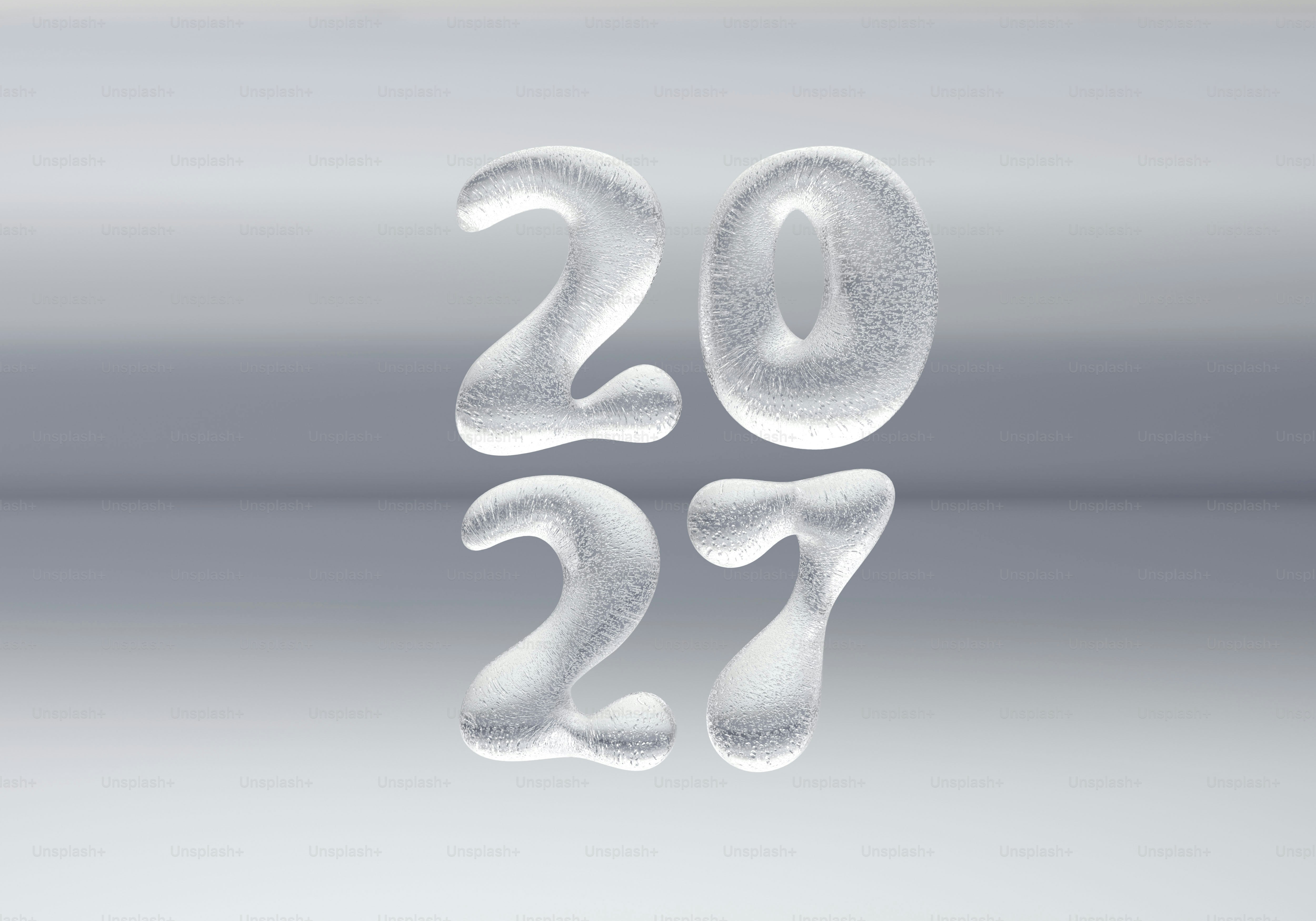 The numbers 2027 formed from textured ice against a soft grey background