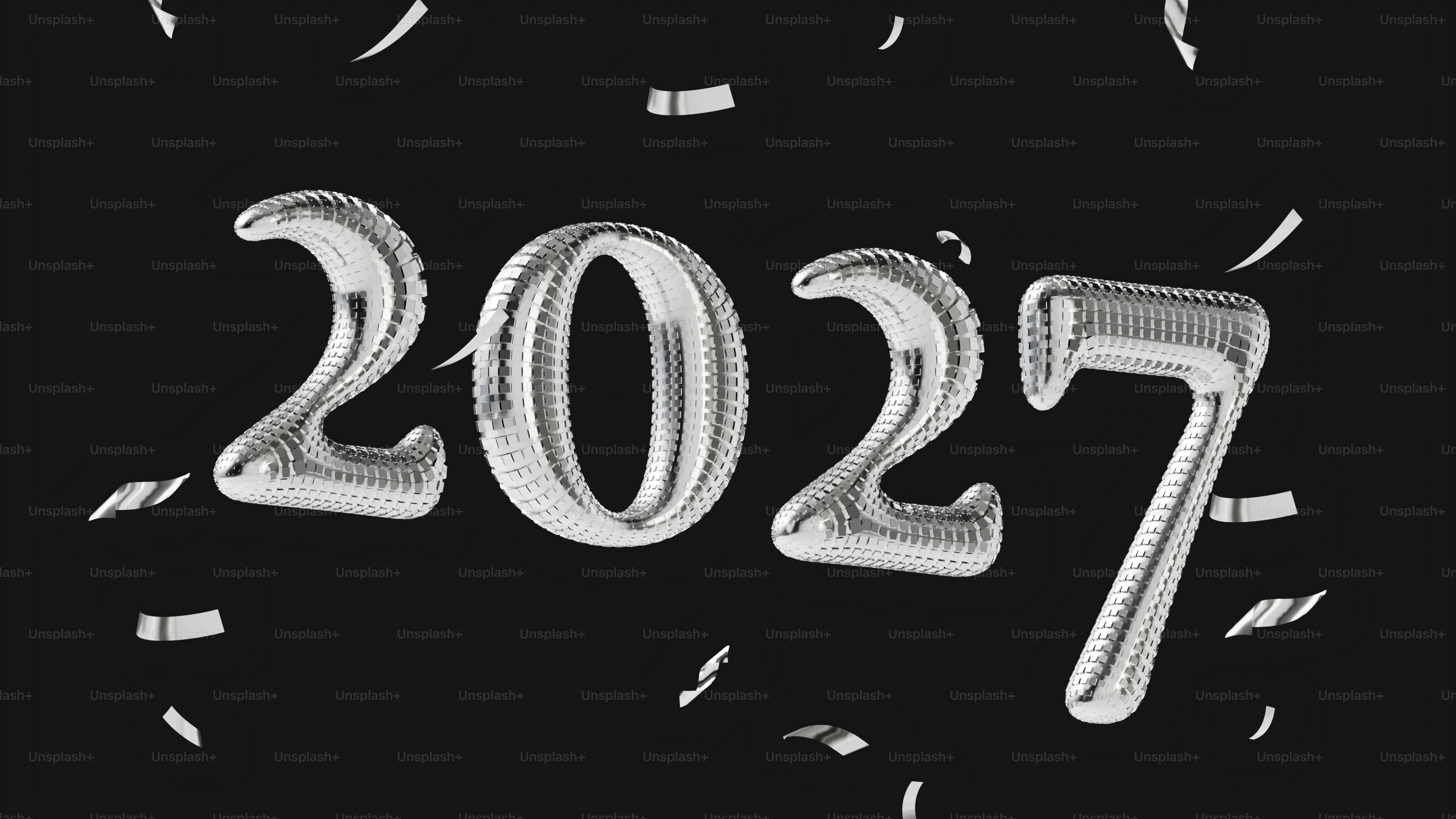은색 디스코 볼 스타일의 풍선들이 2027 번호를 형성하고 색종이 조각이 떨어지는 모습을 닮았다
