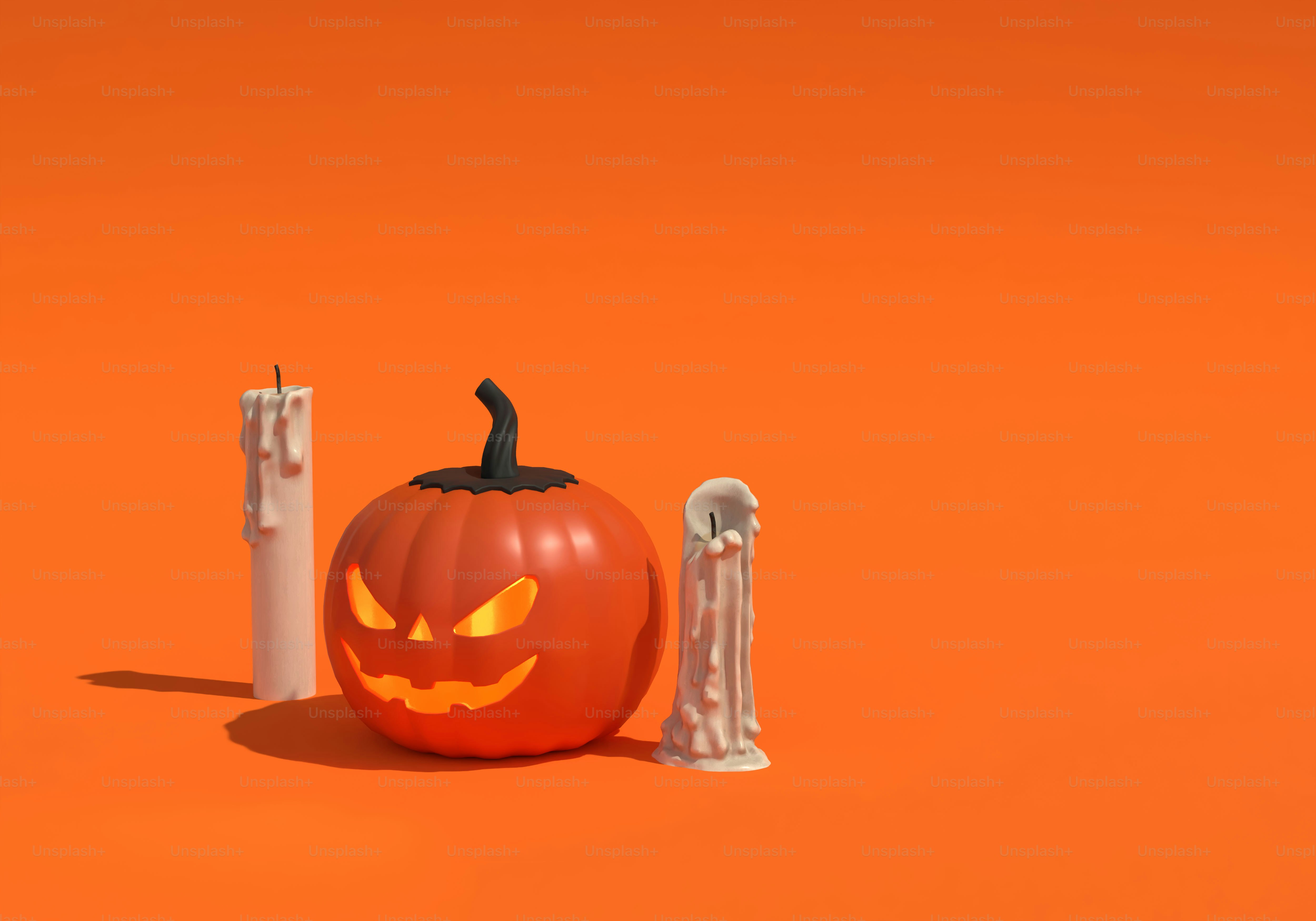 A carved jack-o'-lantern pumpkin glowing between two melting white candles on orange