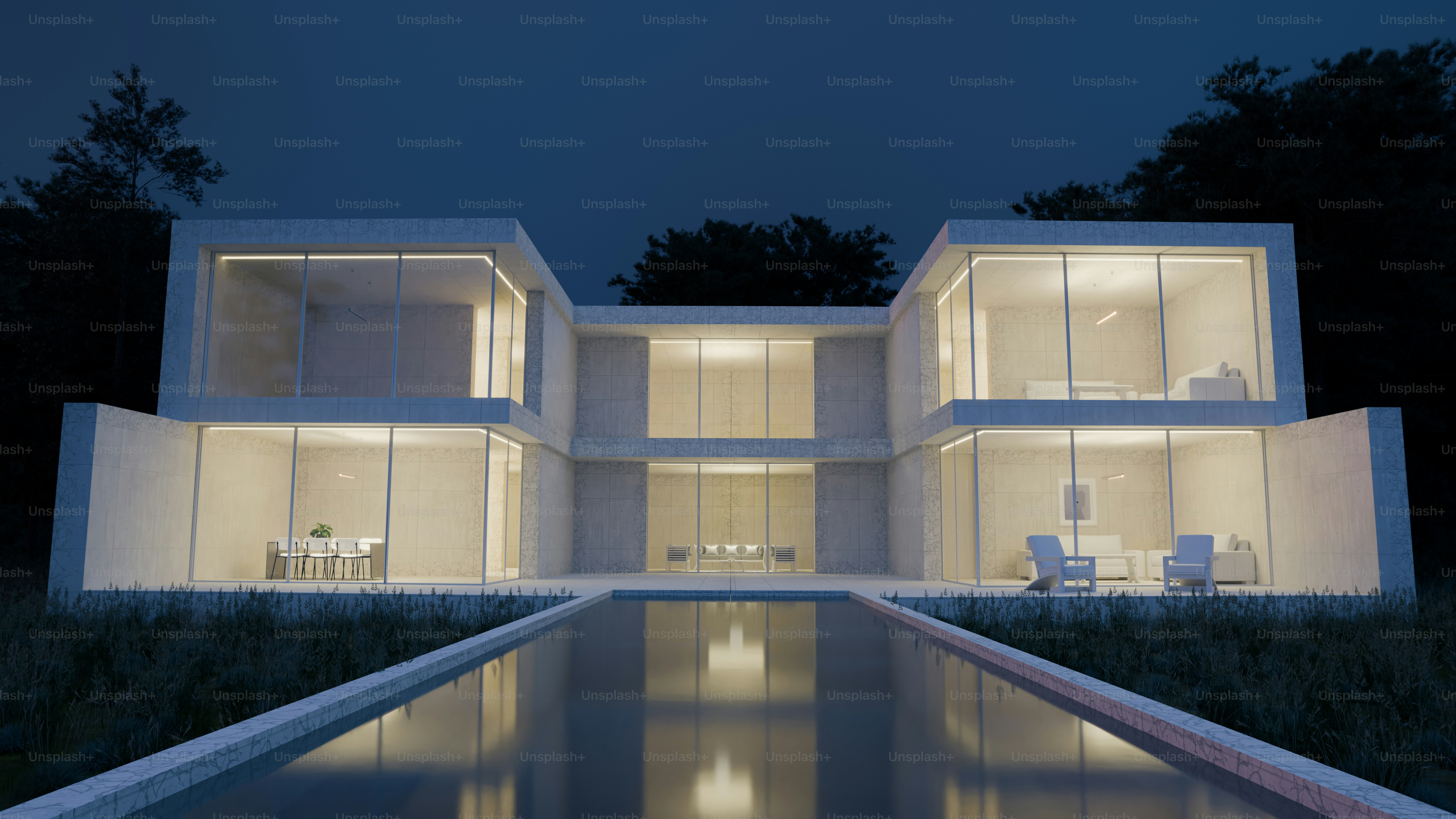 A modern two-story house with glass walls and a swimming pool at night