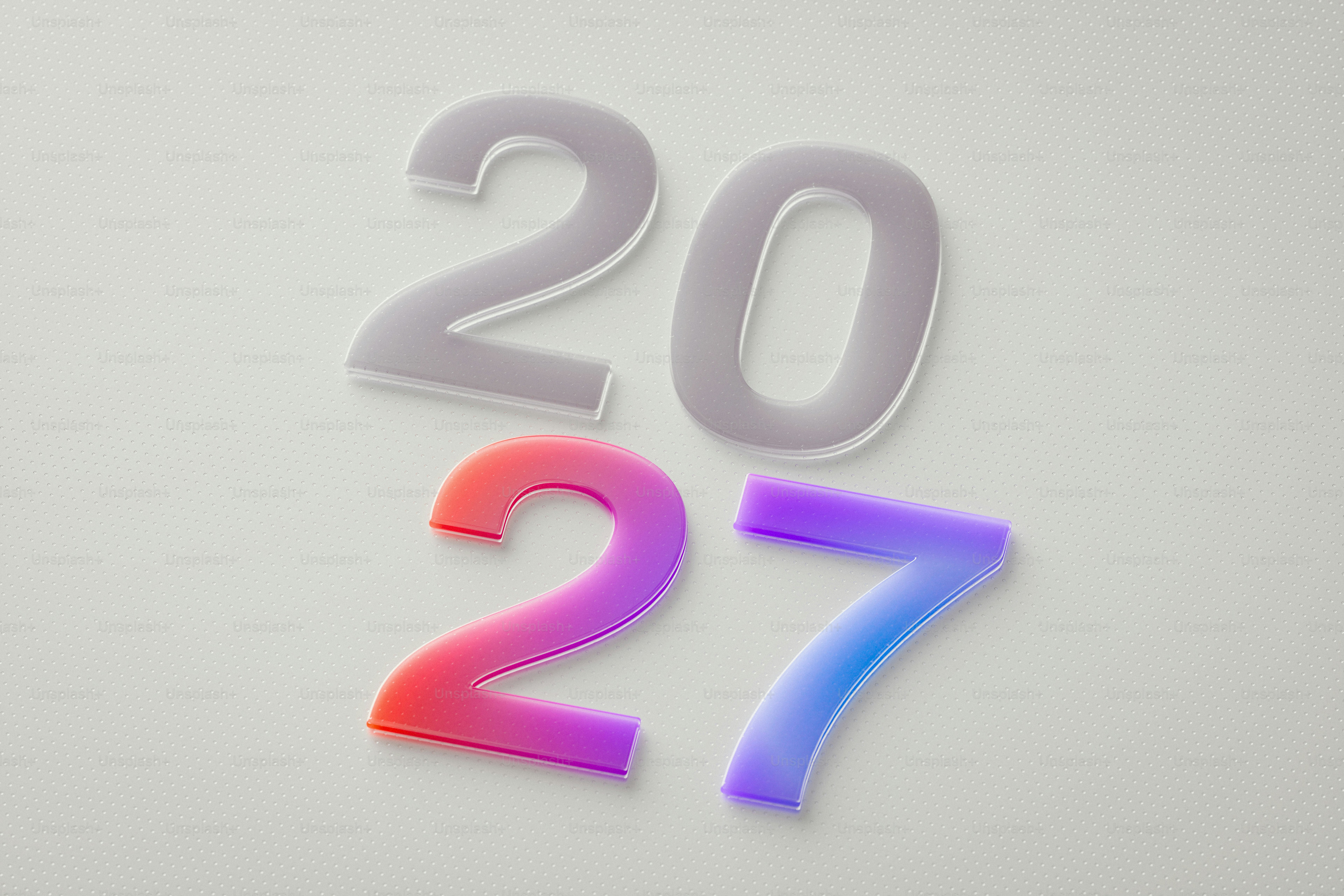The numbers 2027 in frosted and gradient colors on a textured white surface