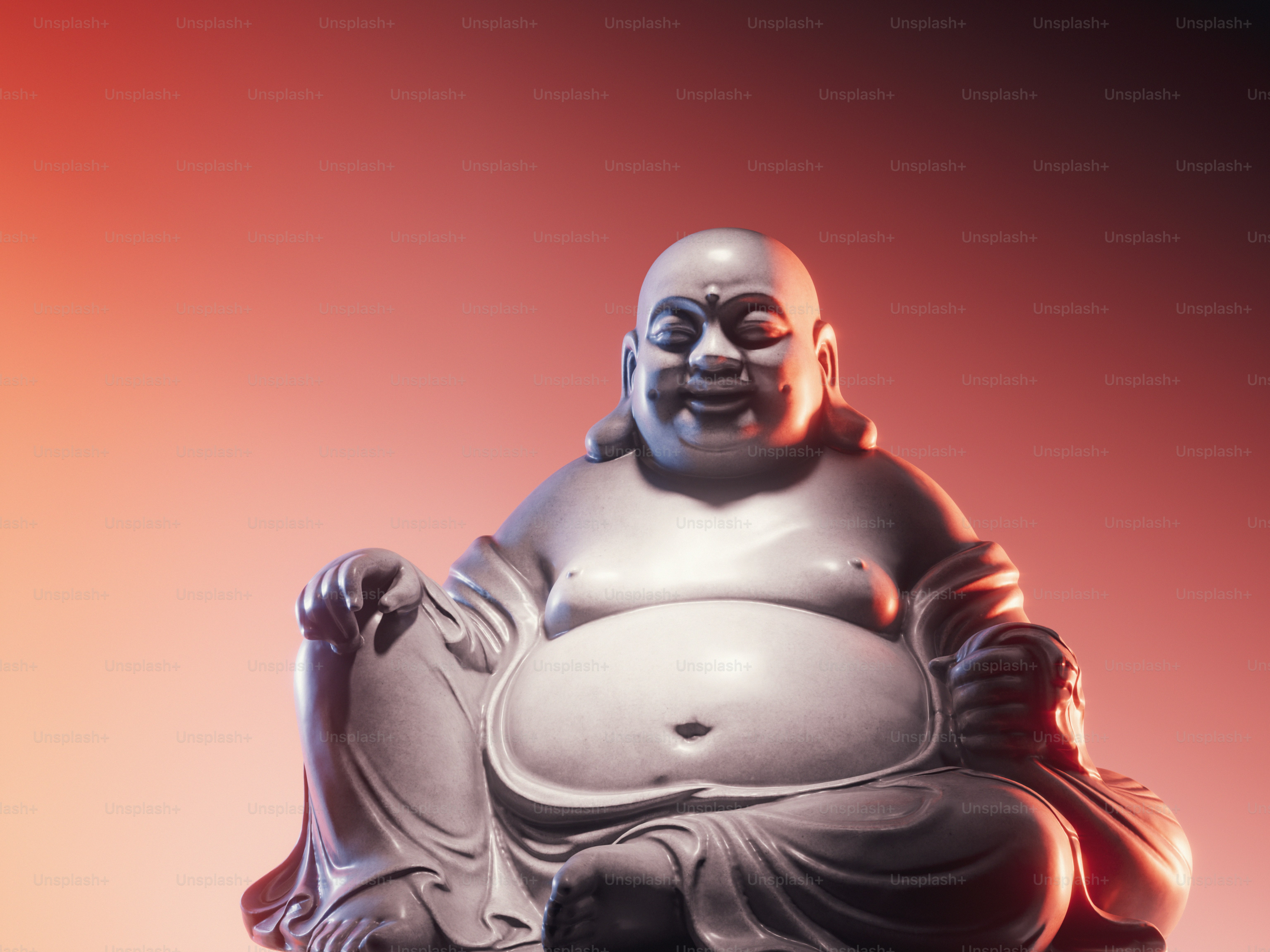 A stone statue of a laughing Buddha against a warm orange gradient background