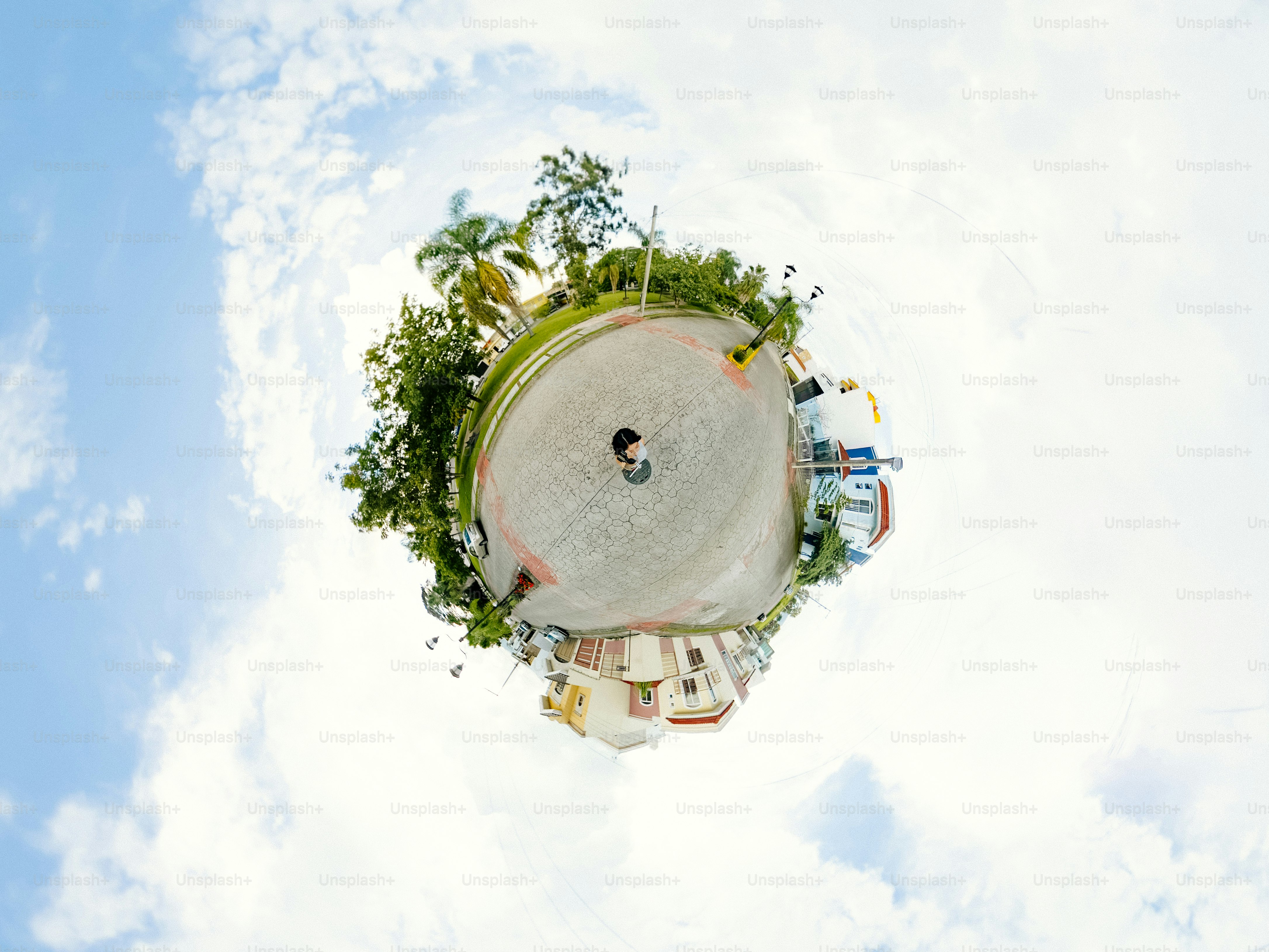 A person standing in the center of a 360 degree panoramic street view