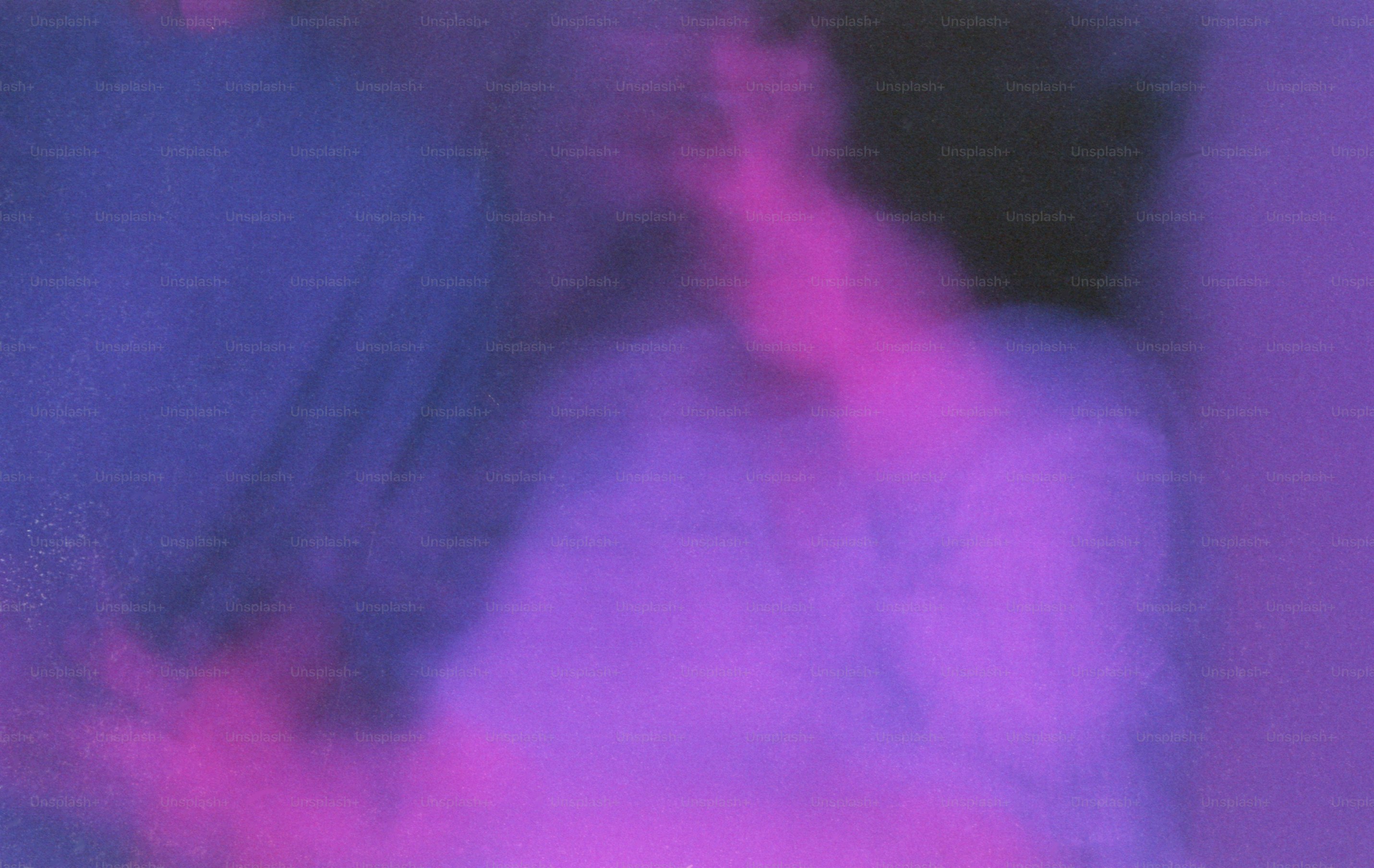 A blurry silhouette of a person against a vibrant purple and blue background