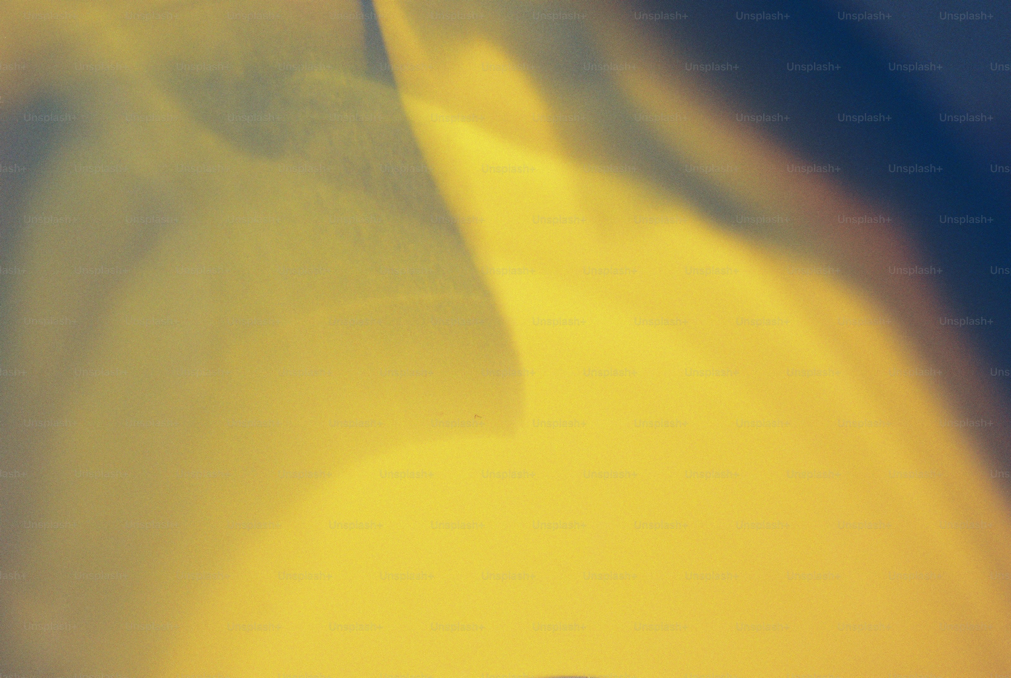 A wash of golden yellow light against a dark blue edge