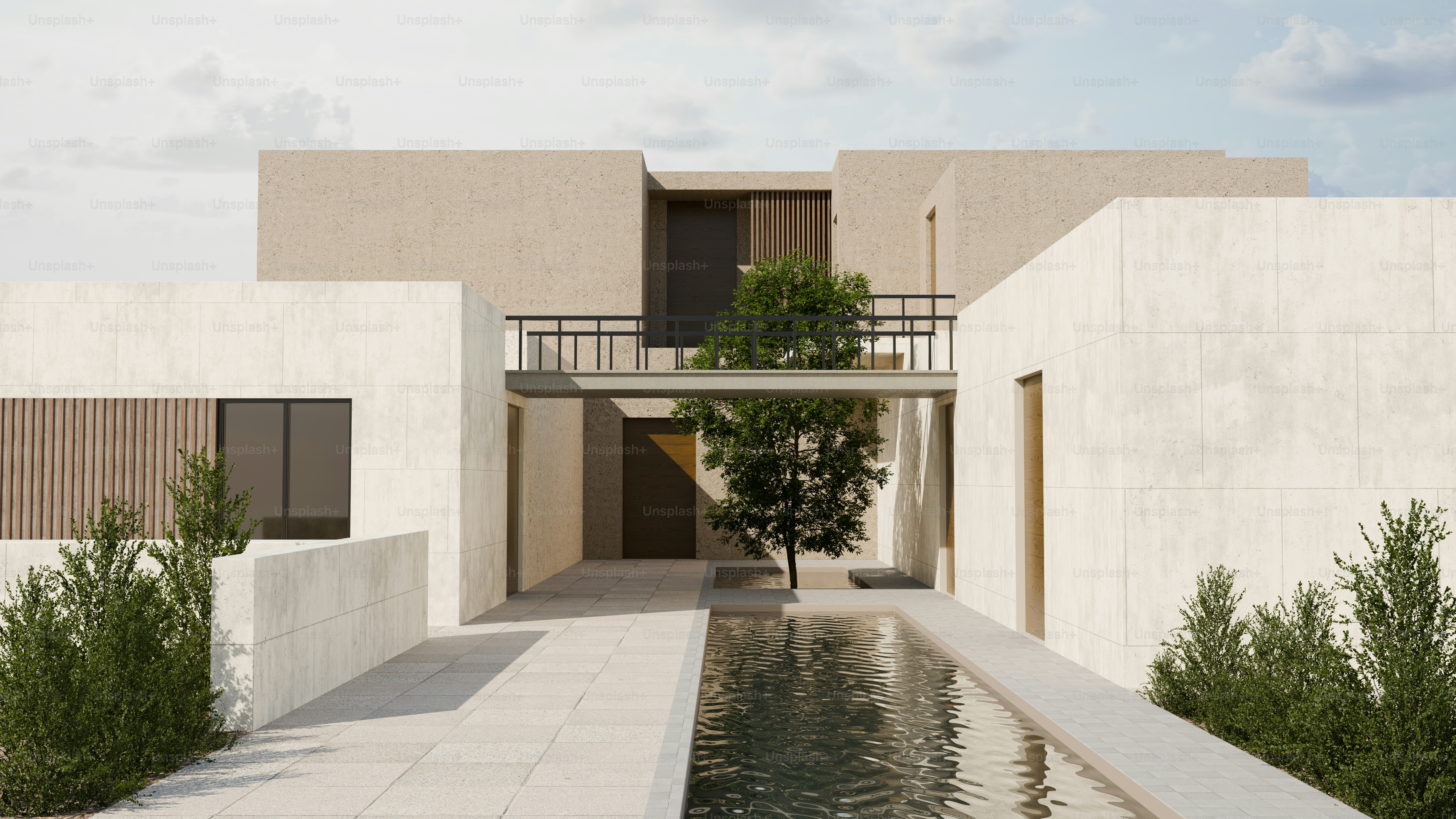 Un bâtiment moderne avec une cour centrale, un arbre et un bassin réfléchissant