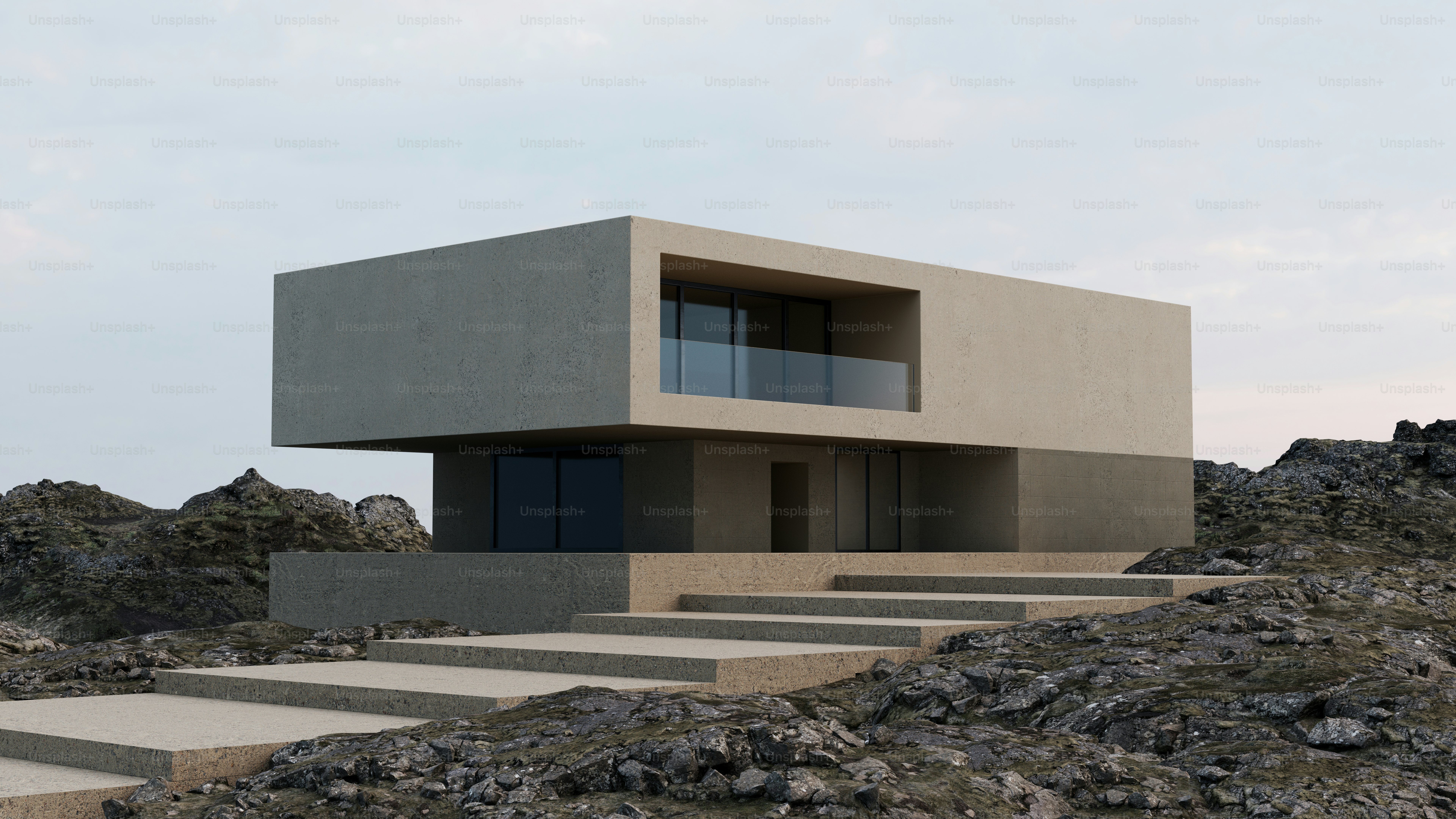 Une maison moderne en béton avec un niveau supérieur en porte-à-faux sur un paysage rocheux