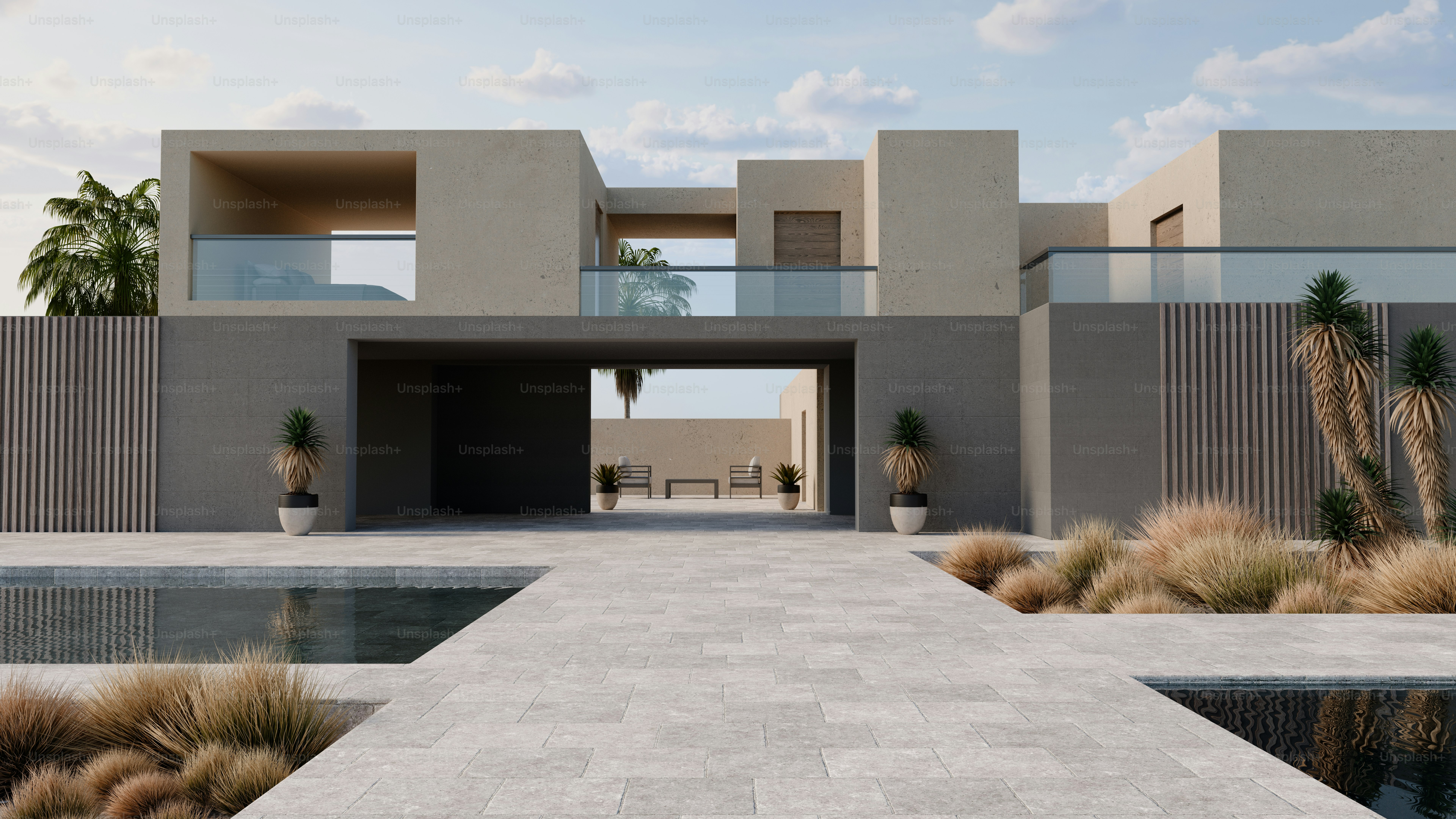 A modern concrete villa with a swimming pool and palm trees under a blue sky