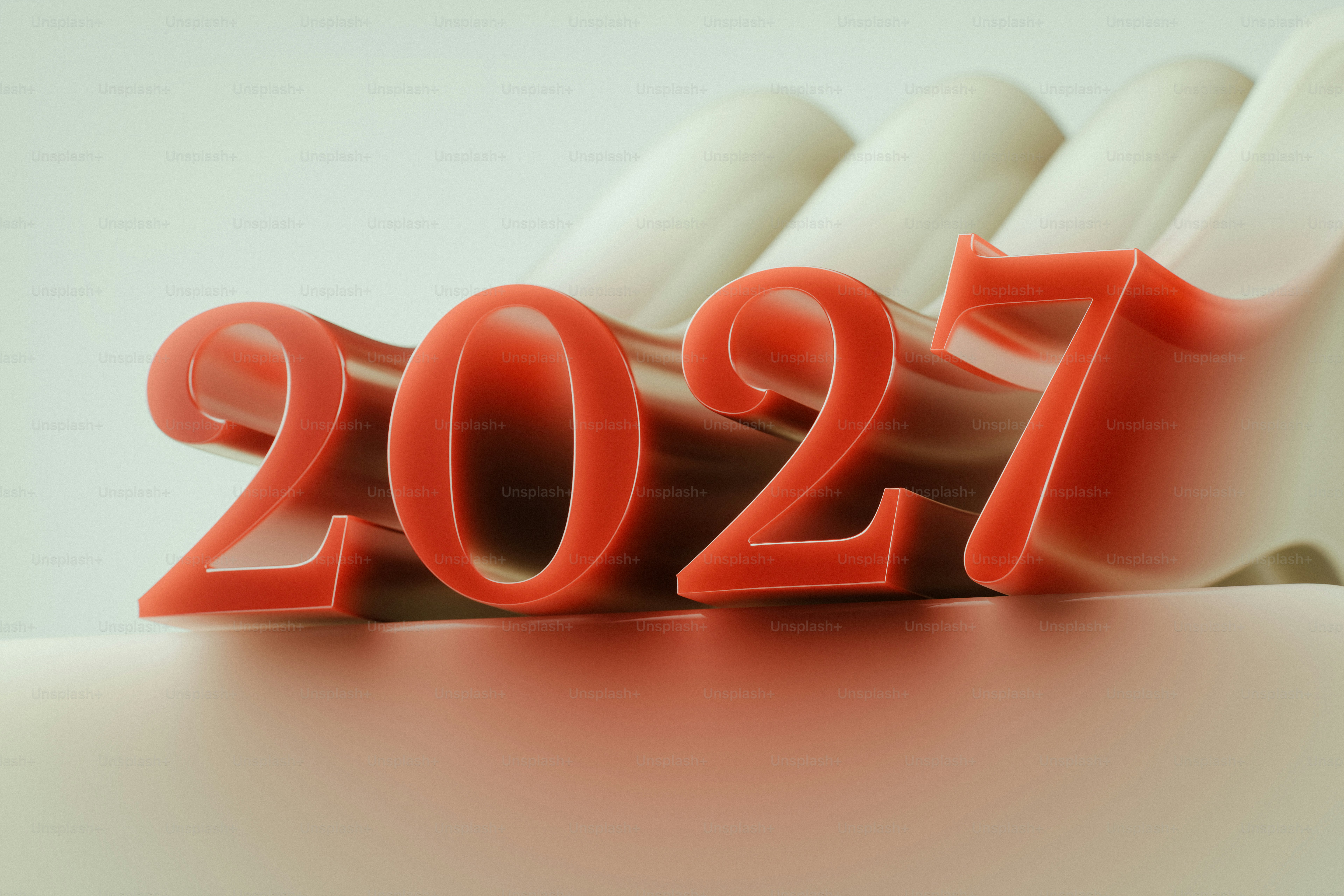 Red 3D numbers 2027 resting on a smooth white curved surface