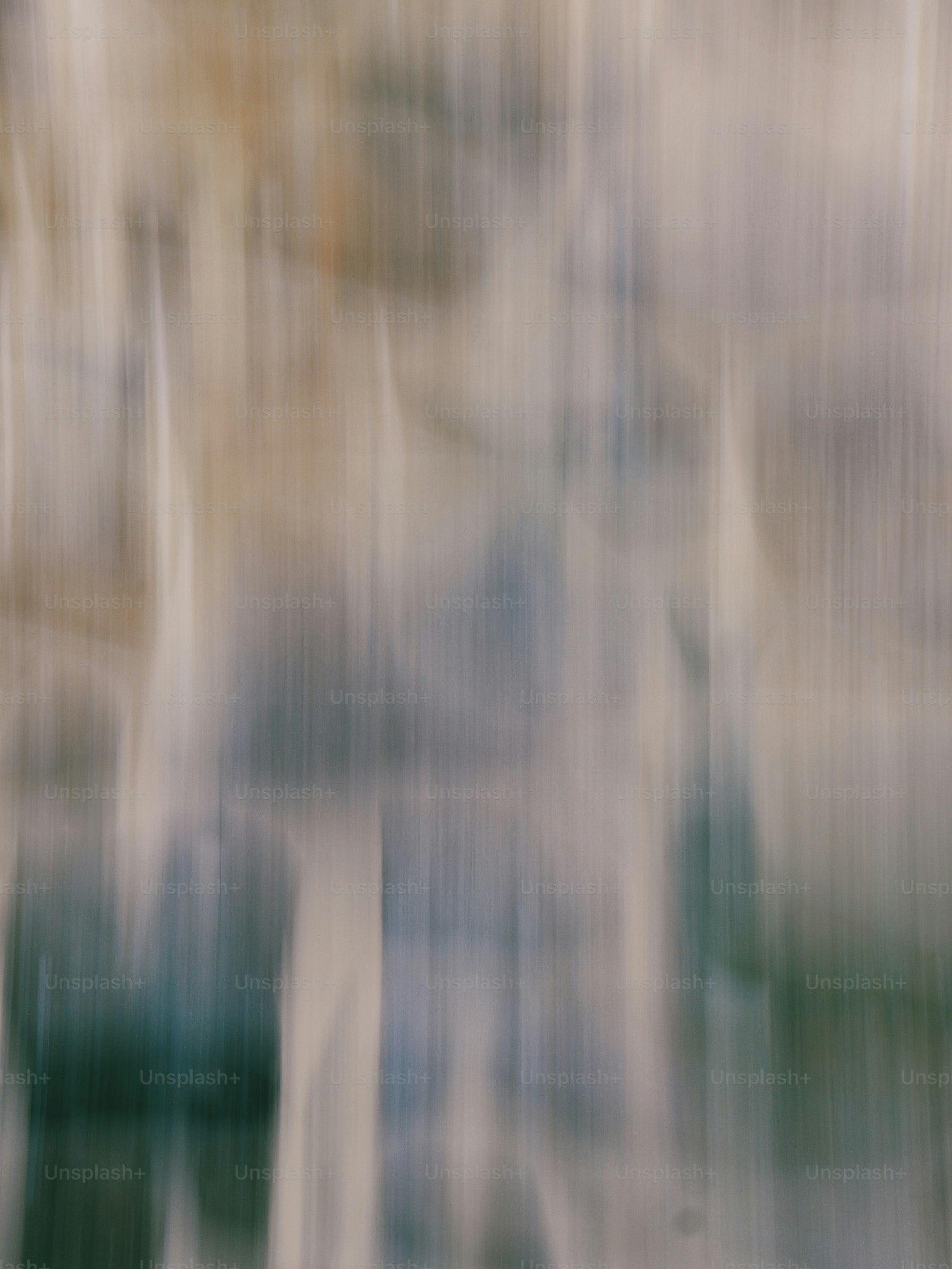 Vertical motion blur with streaks of beige, grey, and muted green