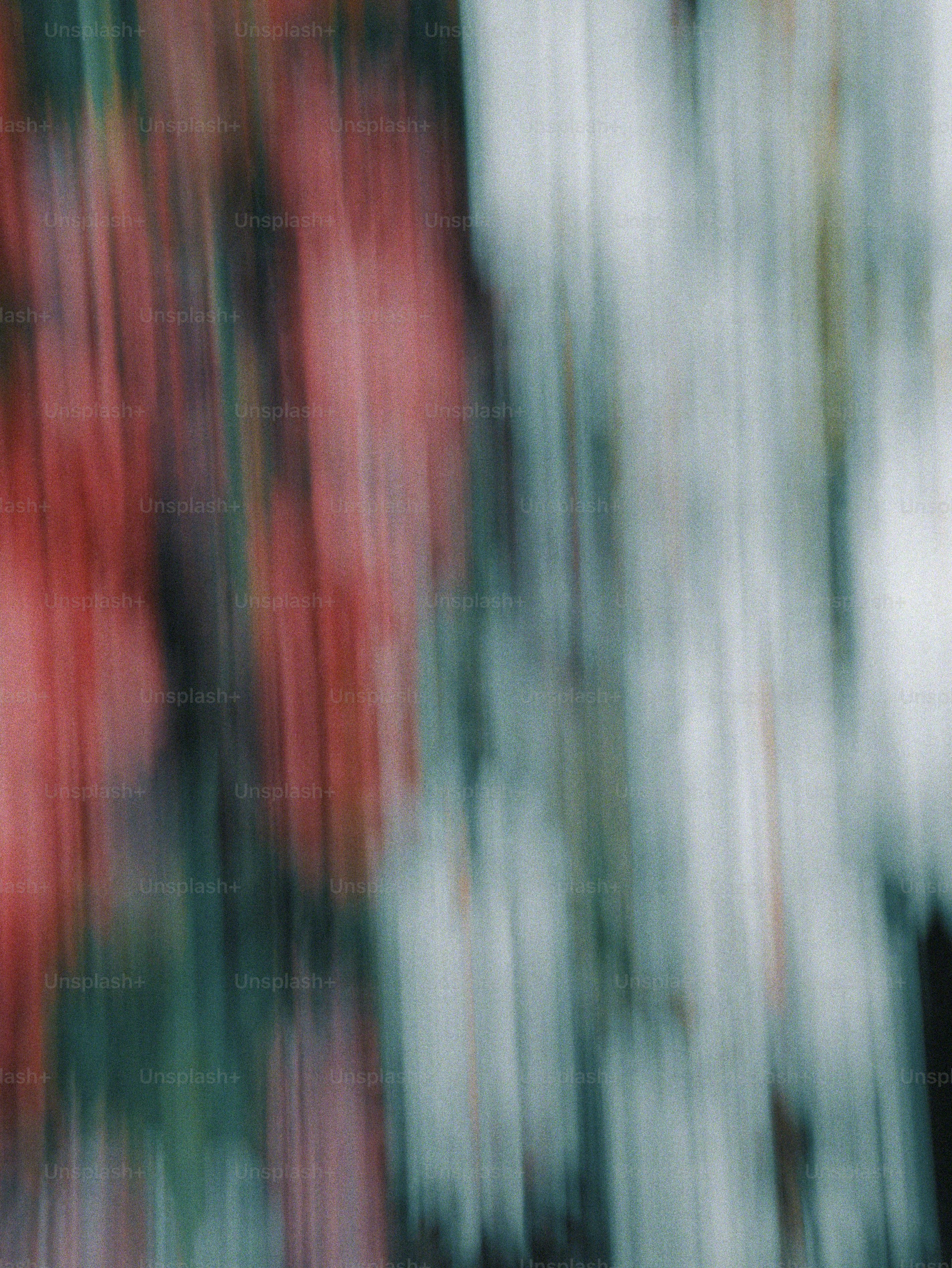 Abstract motion blur with vertical streaks of red, grey, and white