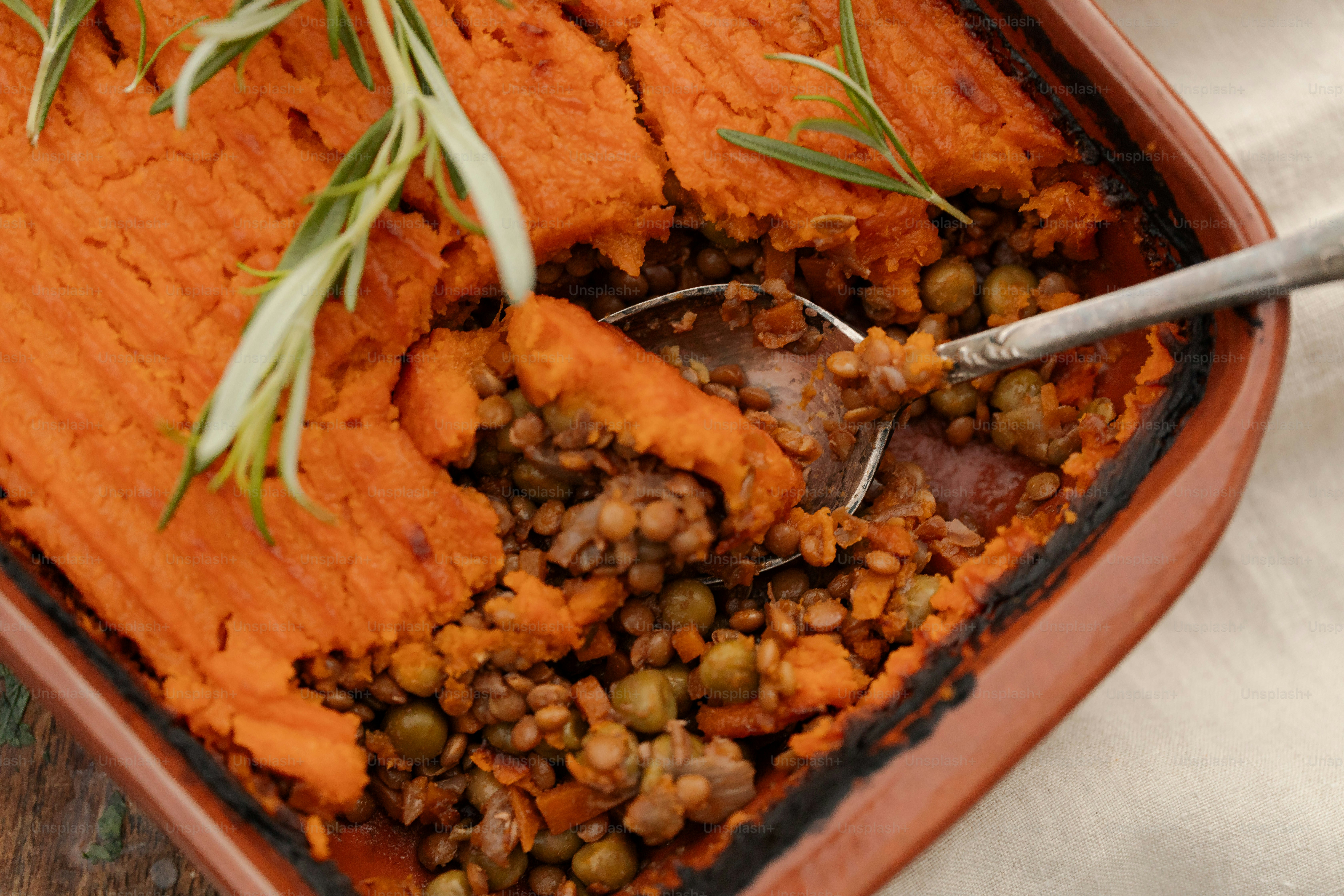 A shepherd's pie with a mashed sweet potato topping and rosemary garnish