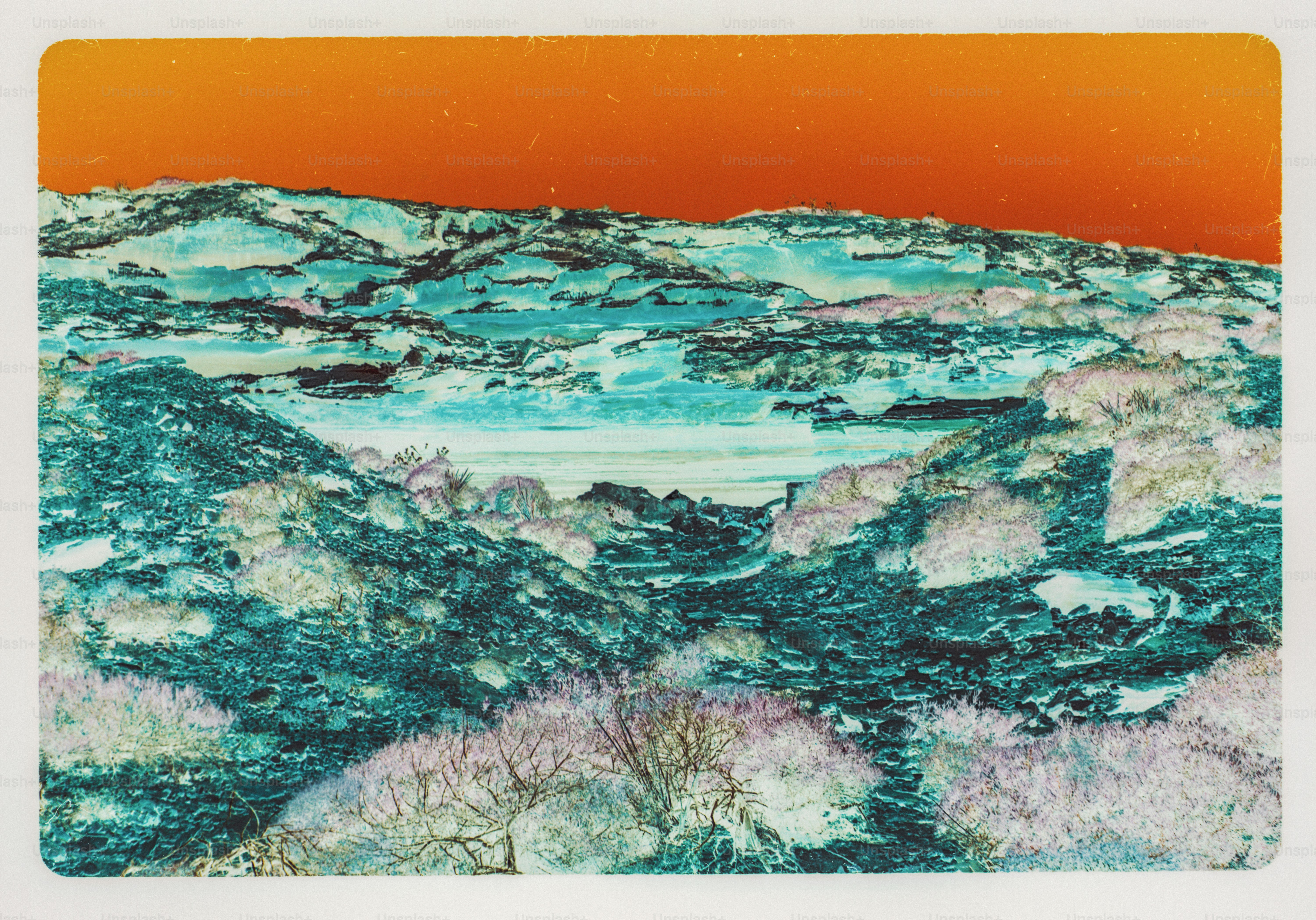Inverted color landscape with blue rocky hills below an orange sky